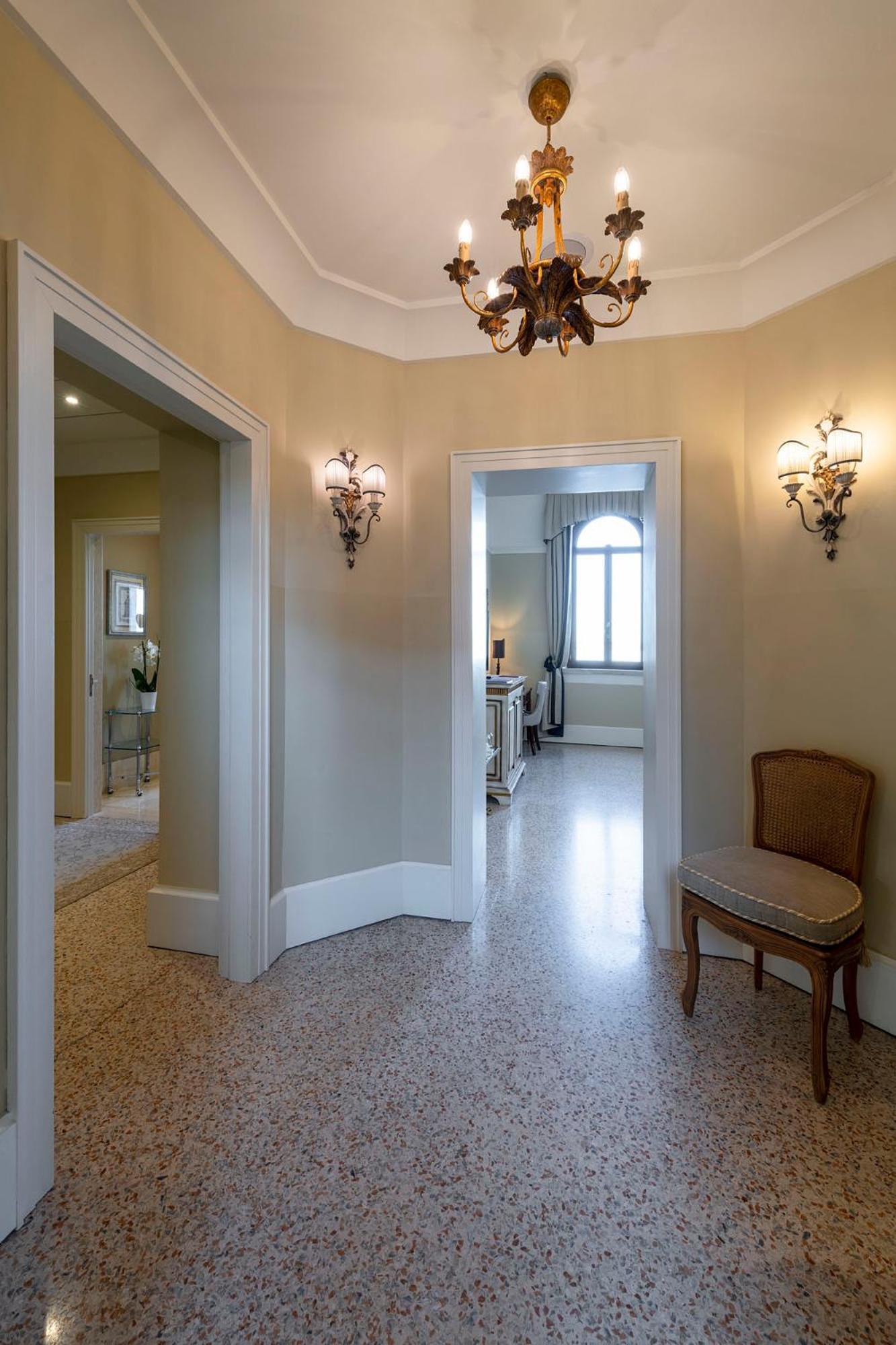 hallway with a chandelier hanging from the ceiling