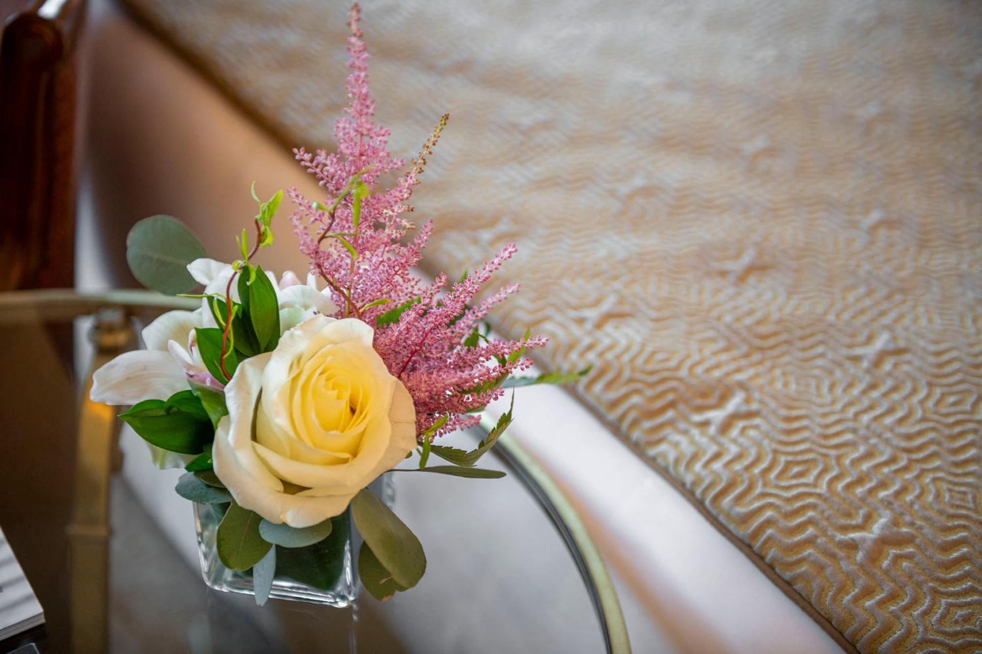 bouquet of flowers in a vase on a glass table