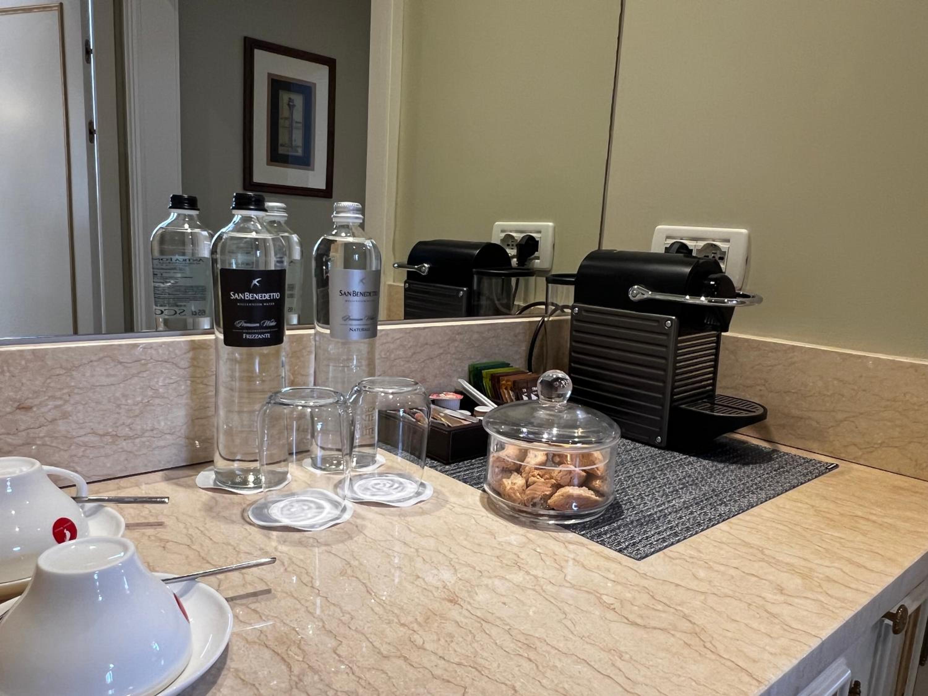 kitchen counter with a coffee maker and cups on it