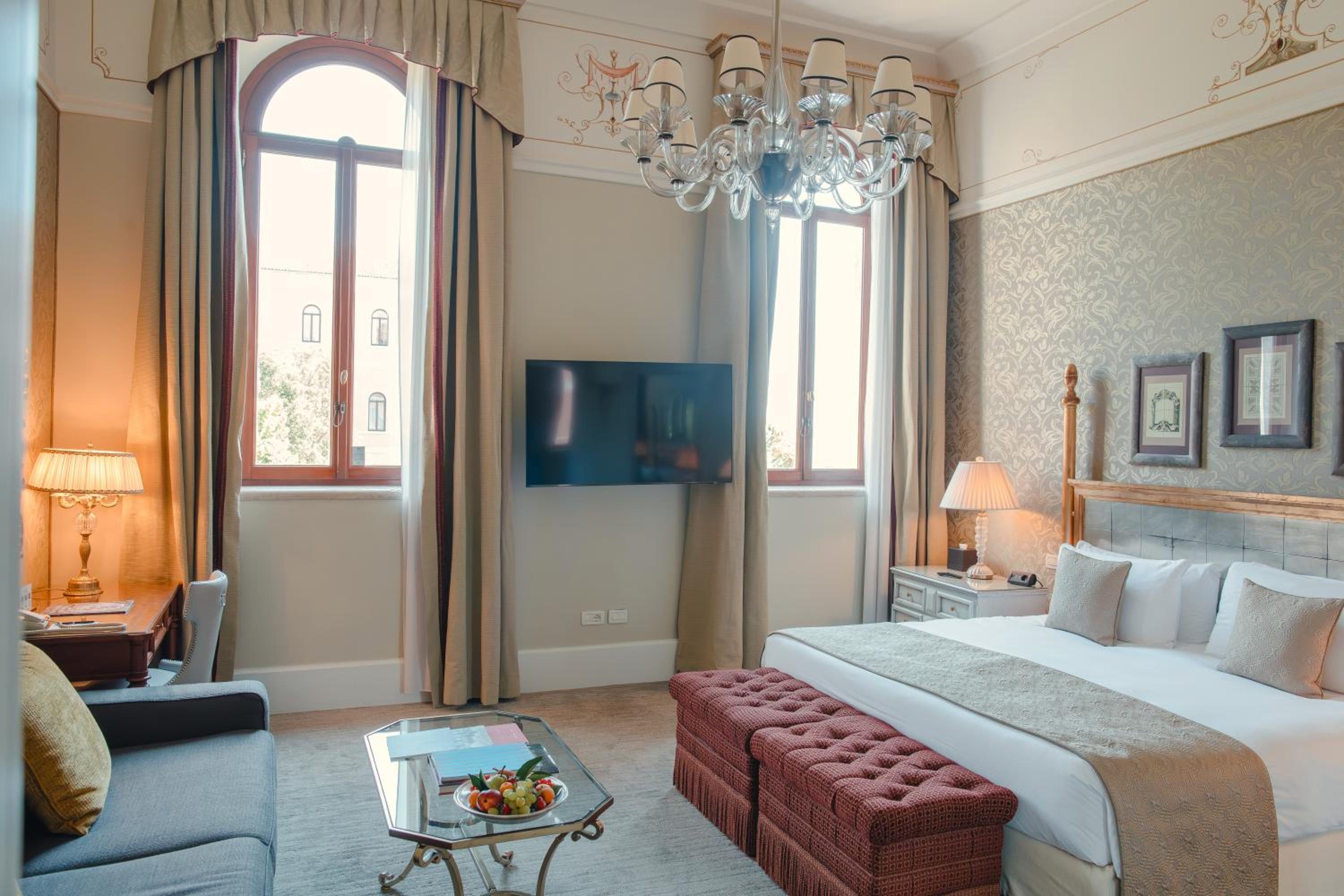 hotel room with a king size bed and chandelier