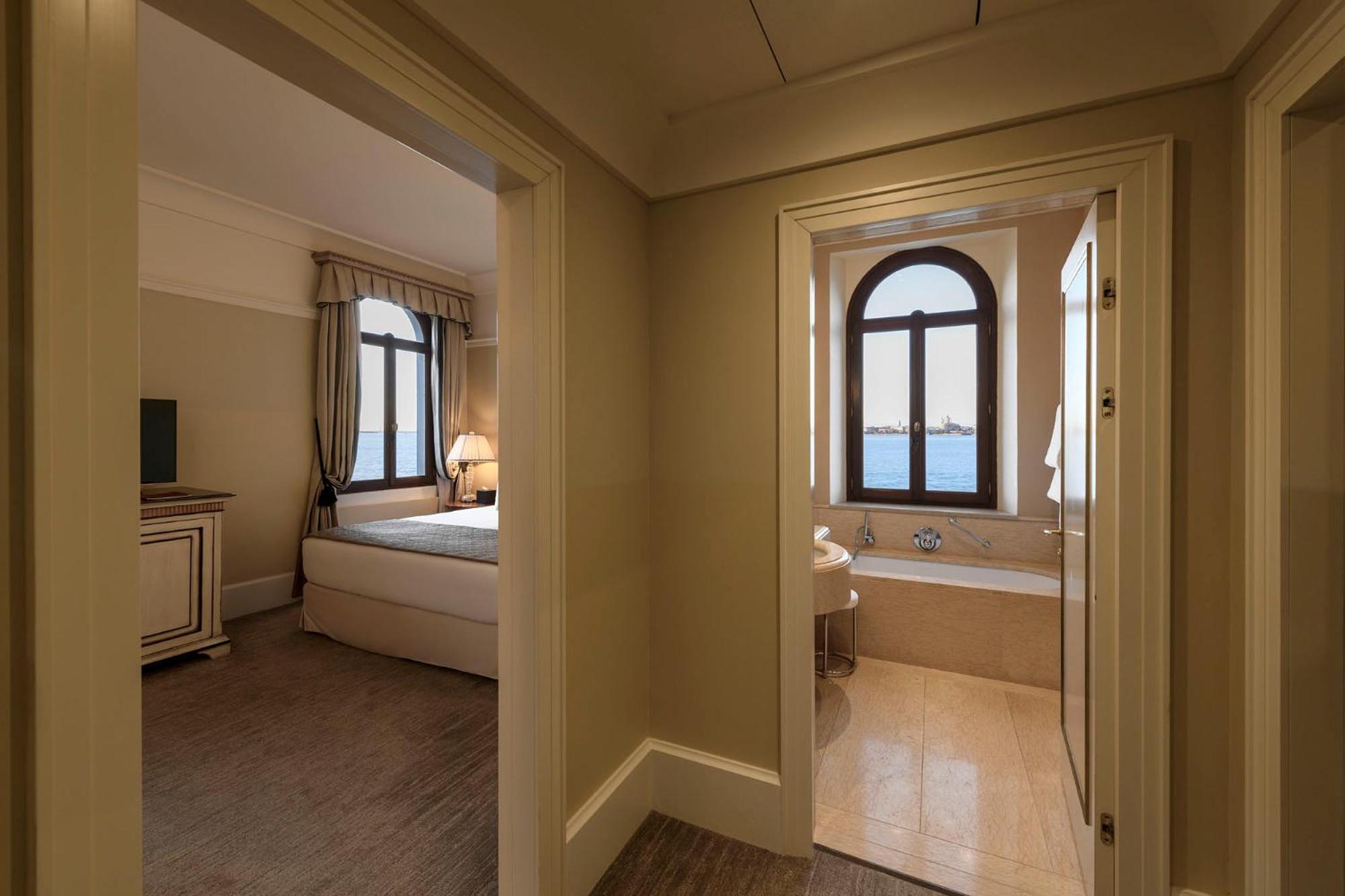 view of a bedroom with a tub and a bed