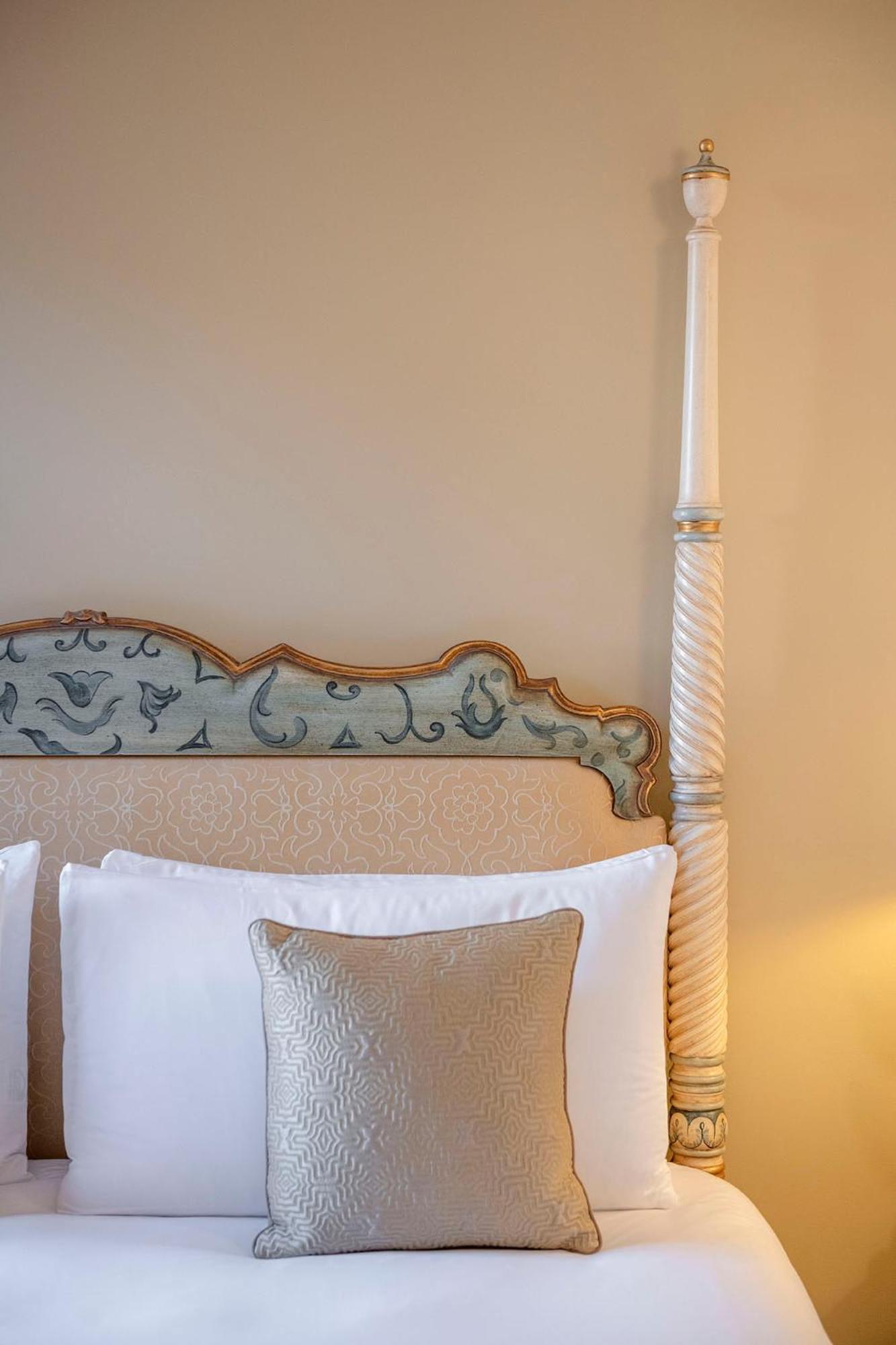 close up of a bed with white sheets and pillows