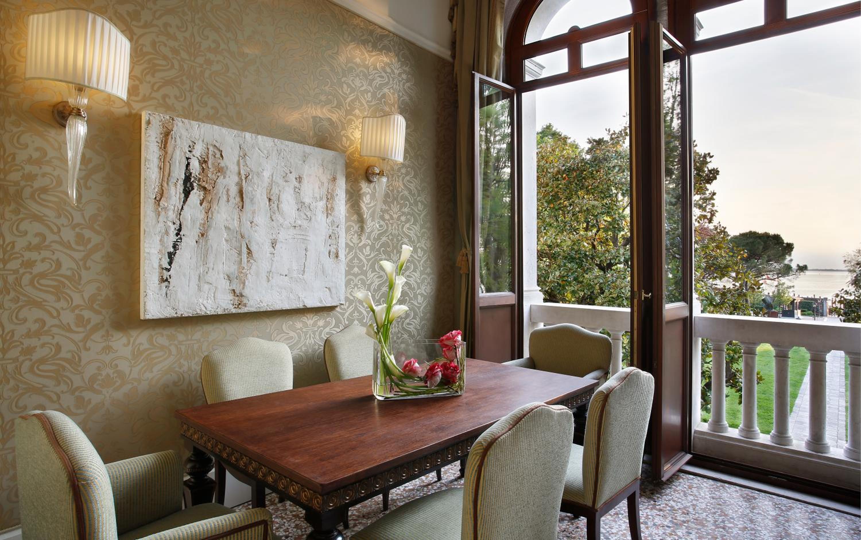 dining room table and chairs with a view of the ocean