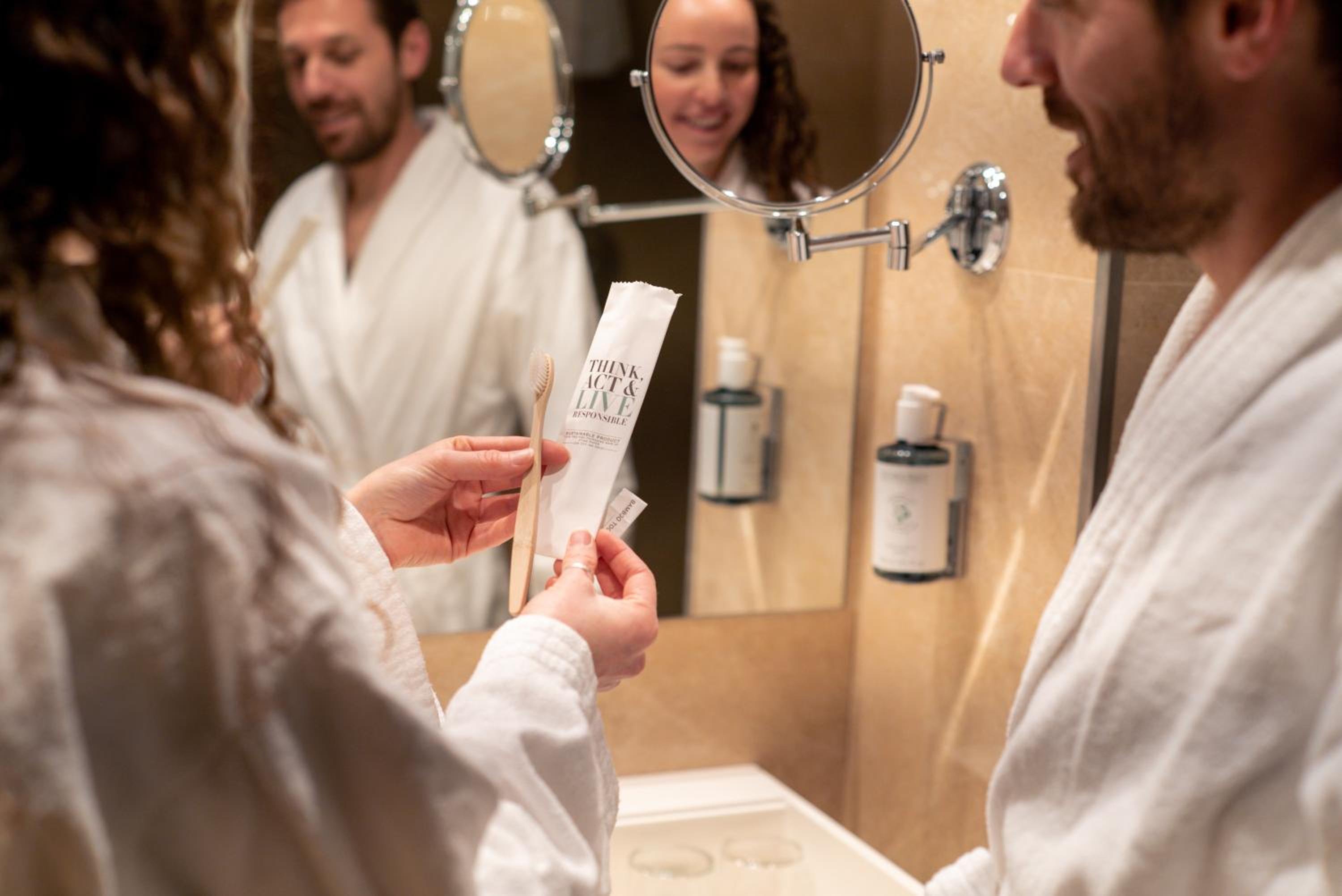 man in a bathrobe getting his hair done