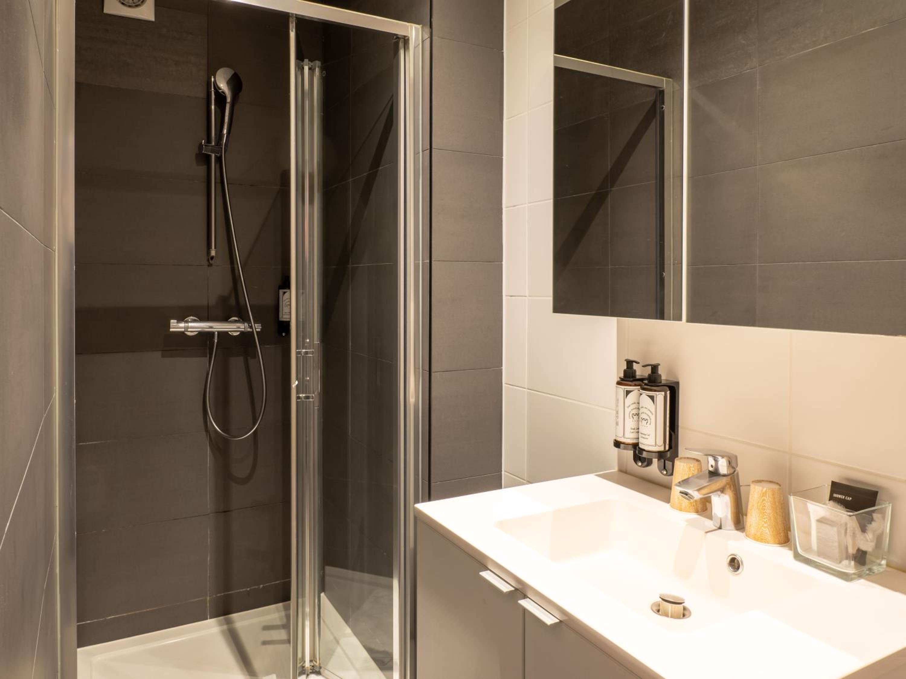 bathroom with a walk - in shower and a sink