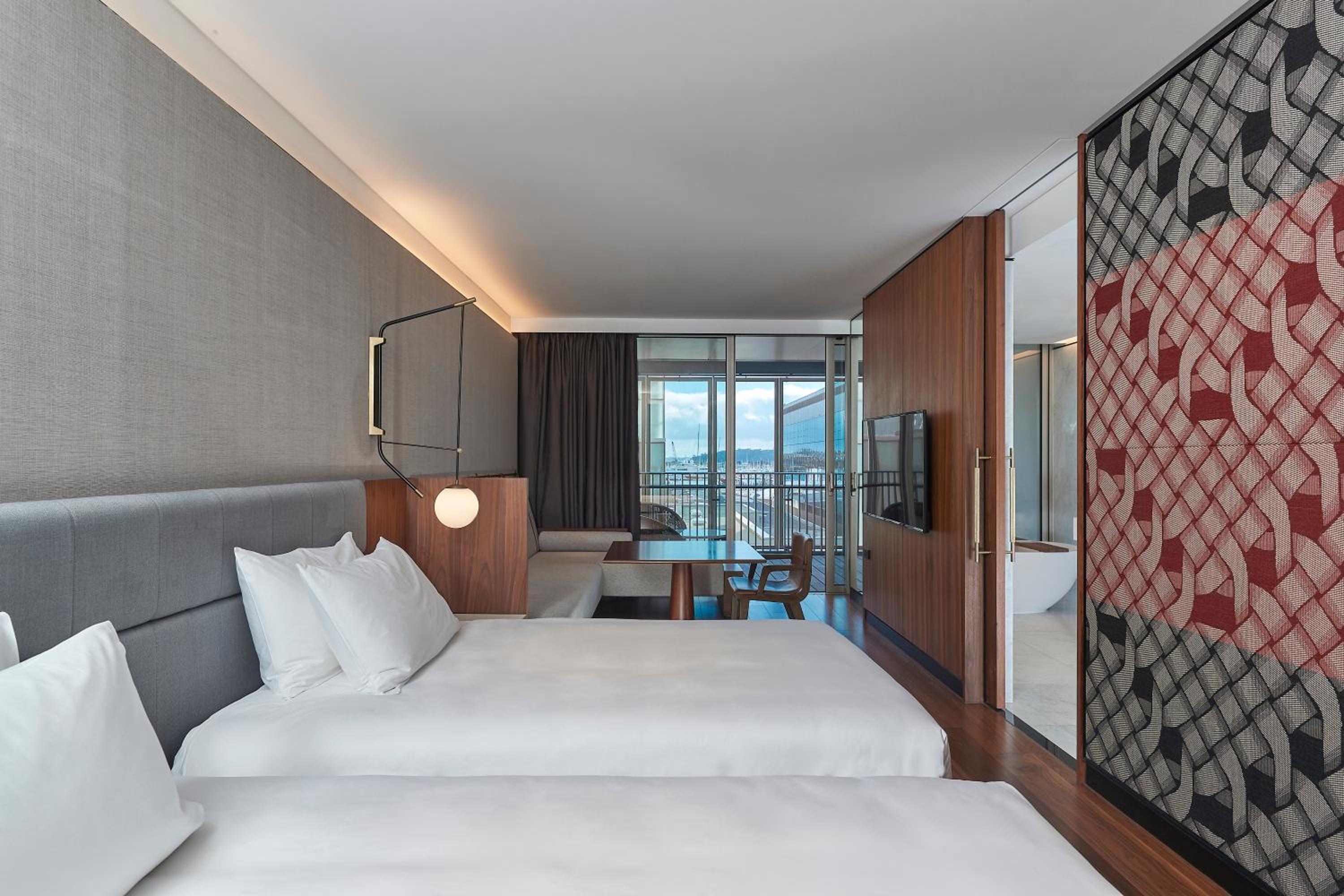 hotel room with two beds and a view of the city