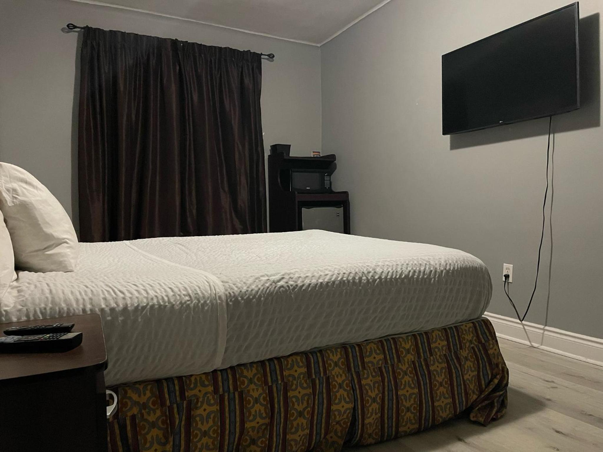 bedroom with a large bed and a flat screen tv