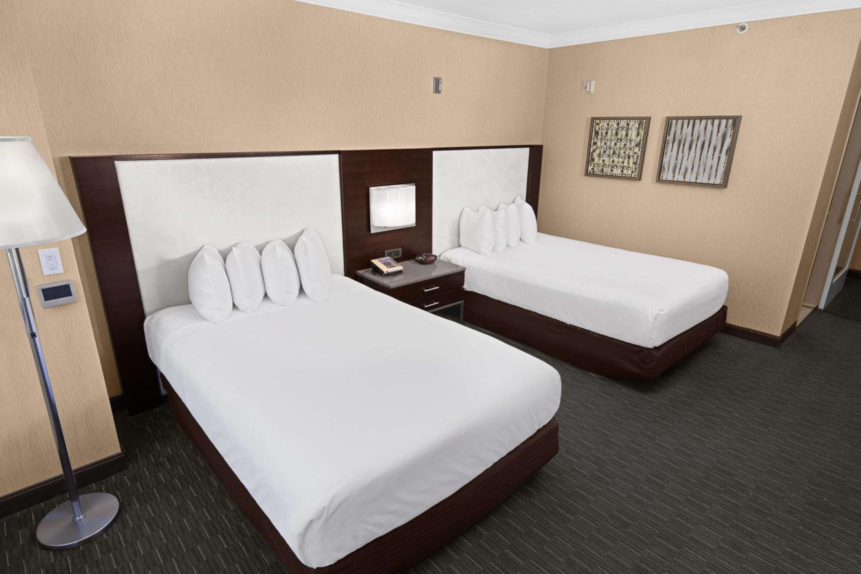 Deluxe Two Queen Beds Mobility/Hearing Accessible Roll in Shower - Photo 1