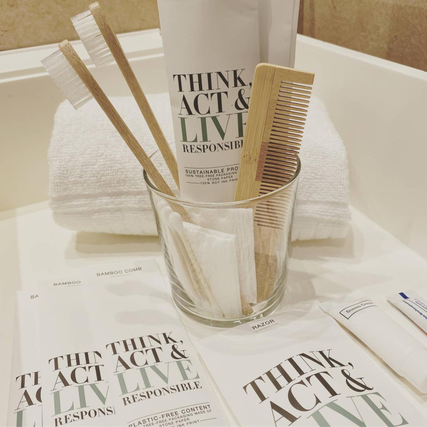 clear glass with toothbrushes and other items in it