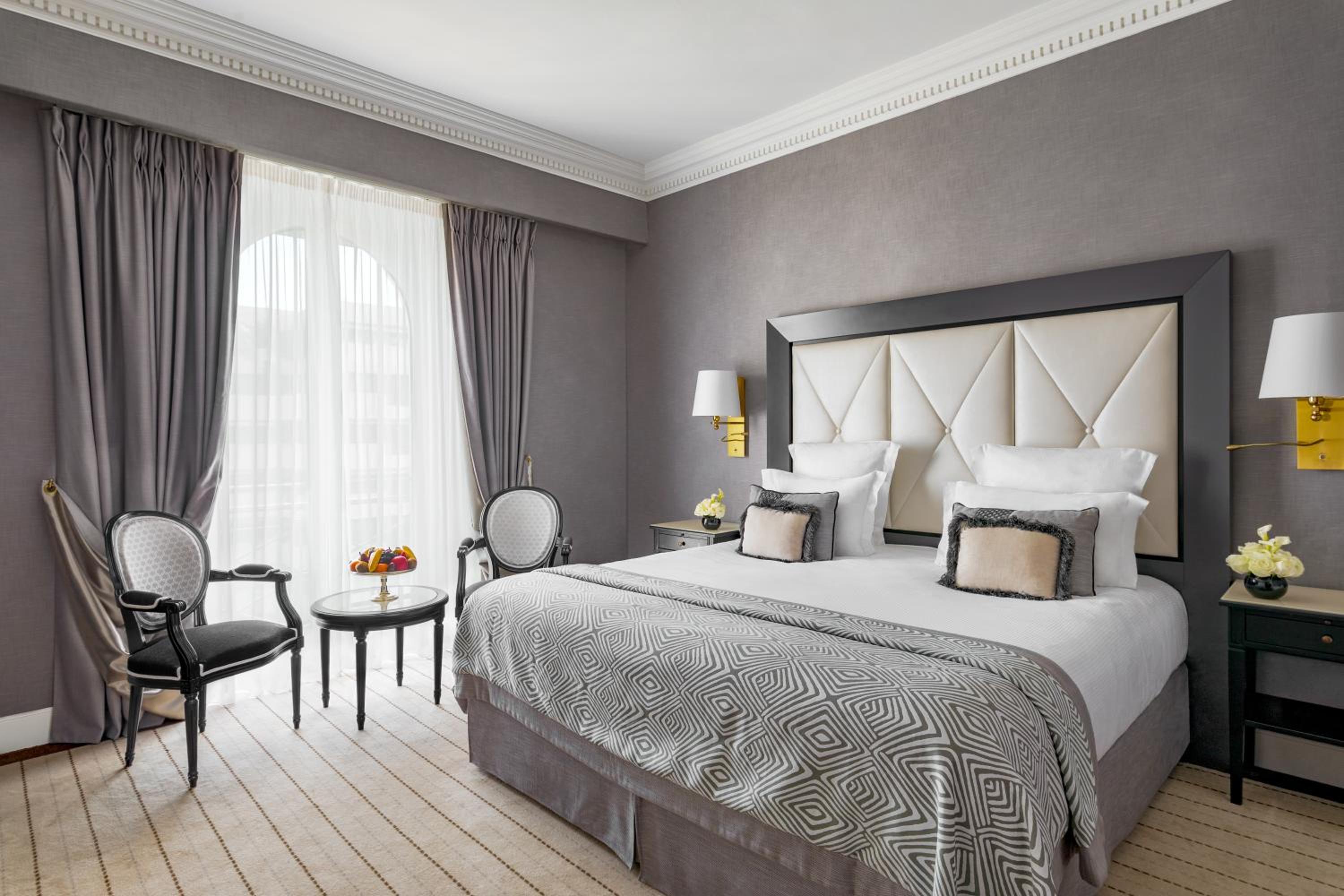 hotel room with a king size bed and two chairs