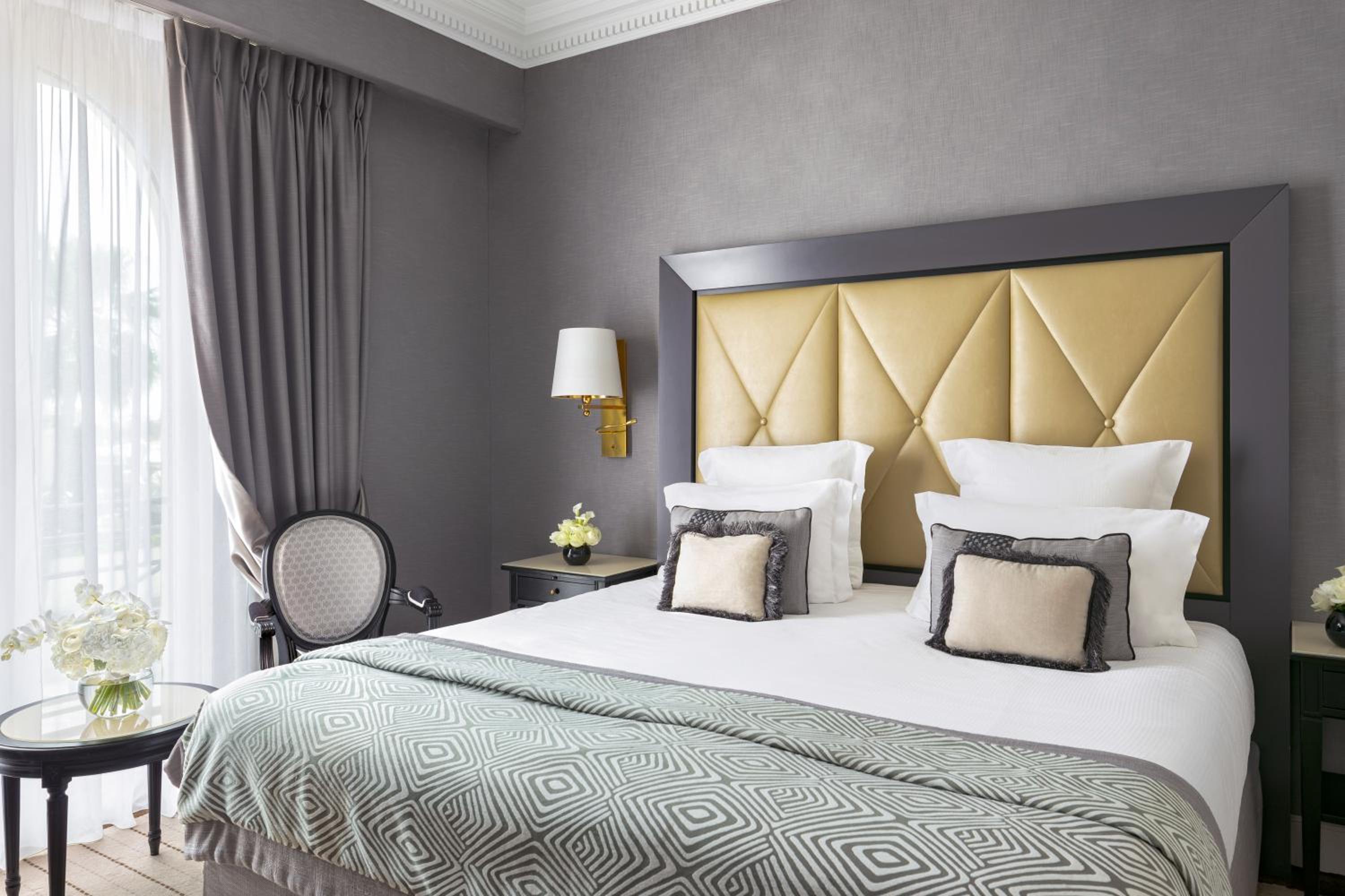 hotel room with a king size bed and yellow headboard