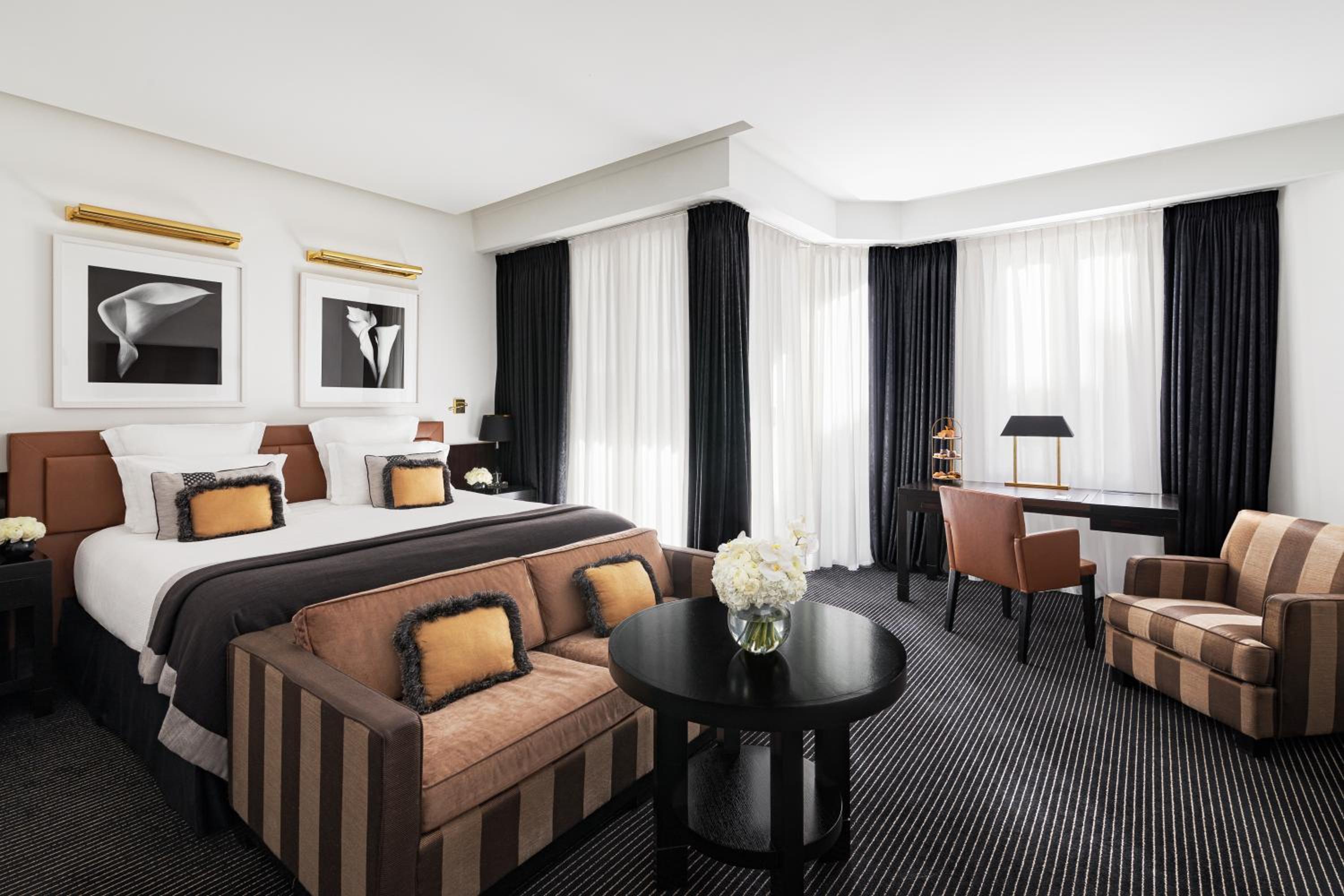 hotel room with a king size bed and two chairs