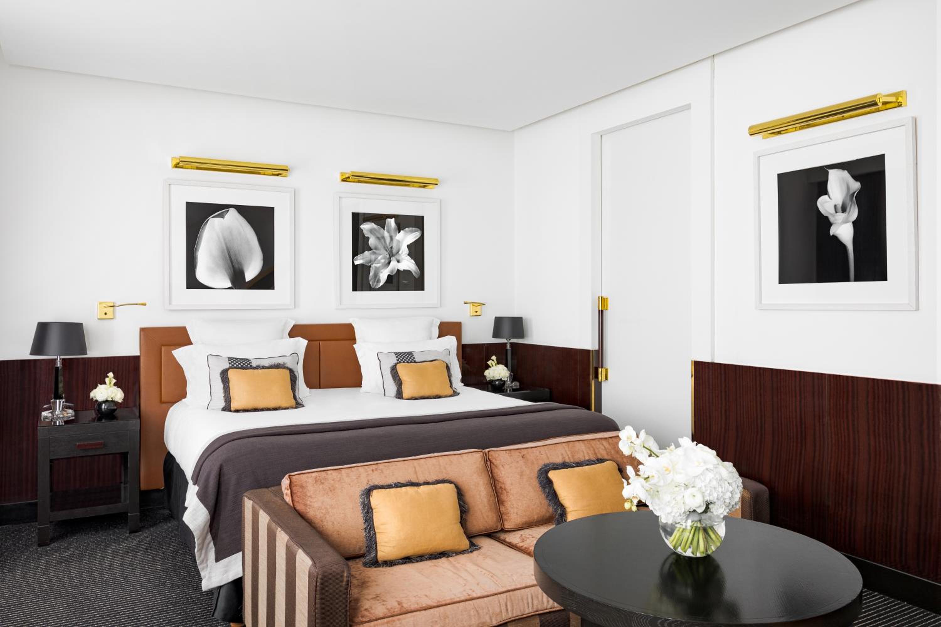 black and white photo of a bed in a hotel room