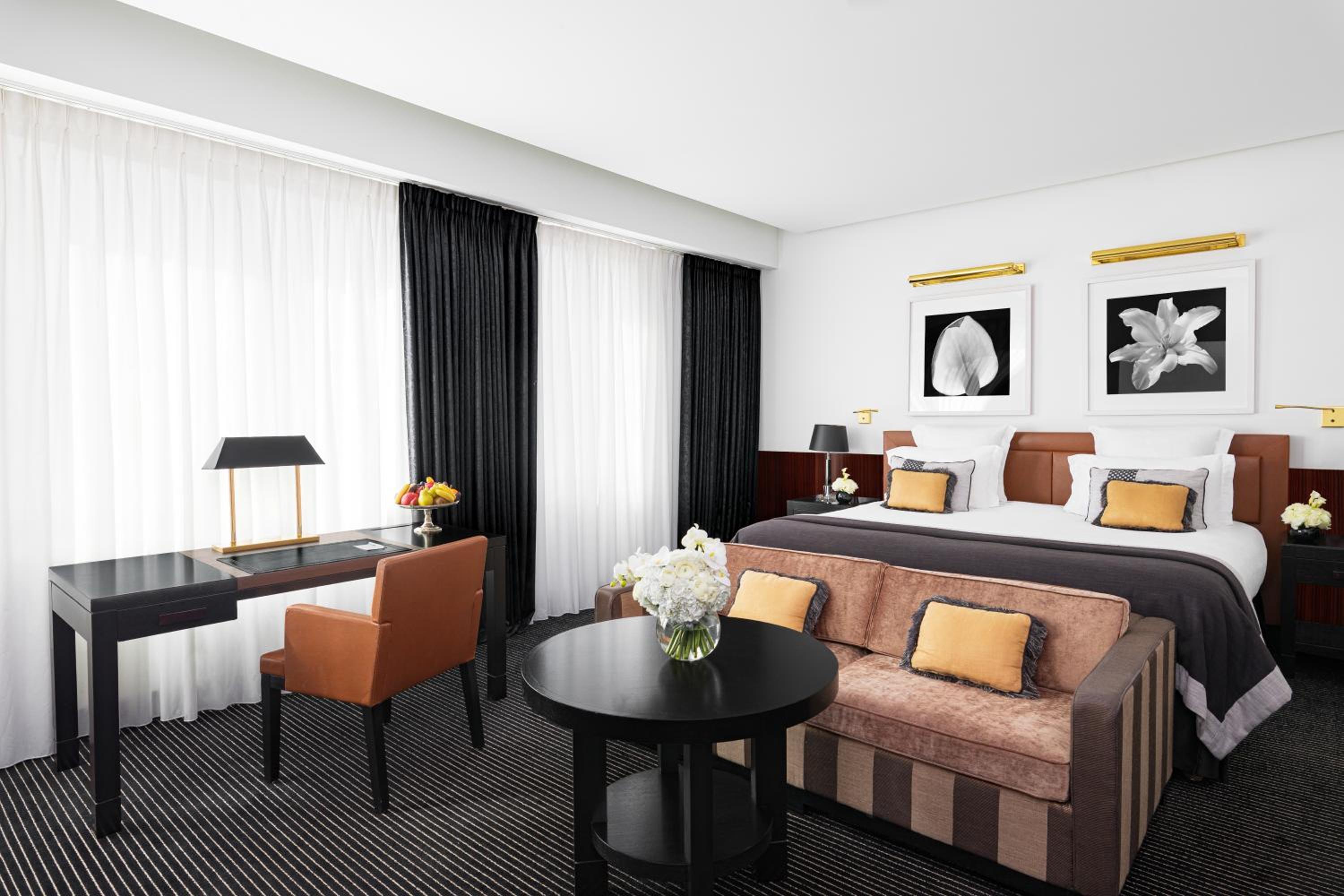 hotel room with a bed, desk, and chair