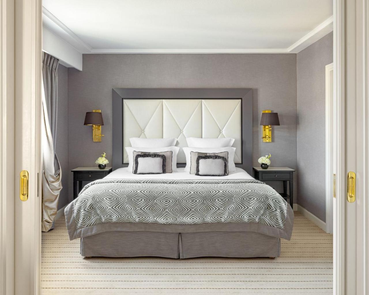 bedroom with a white headboard and gray bedding