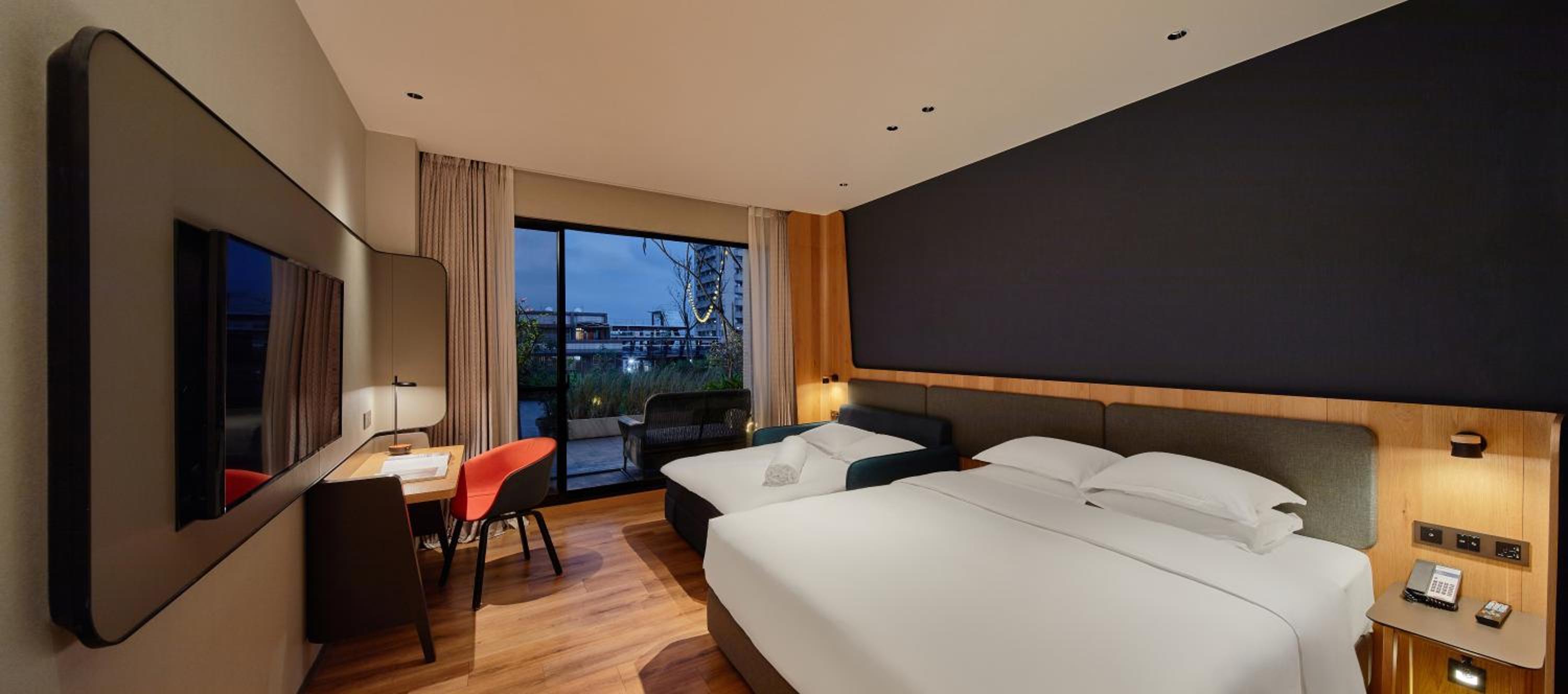 Standard Room with One Queen Bed and One King Bed - Garden View