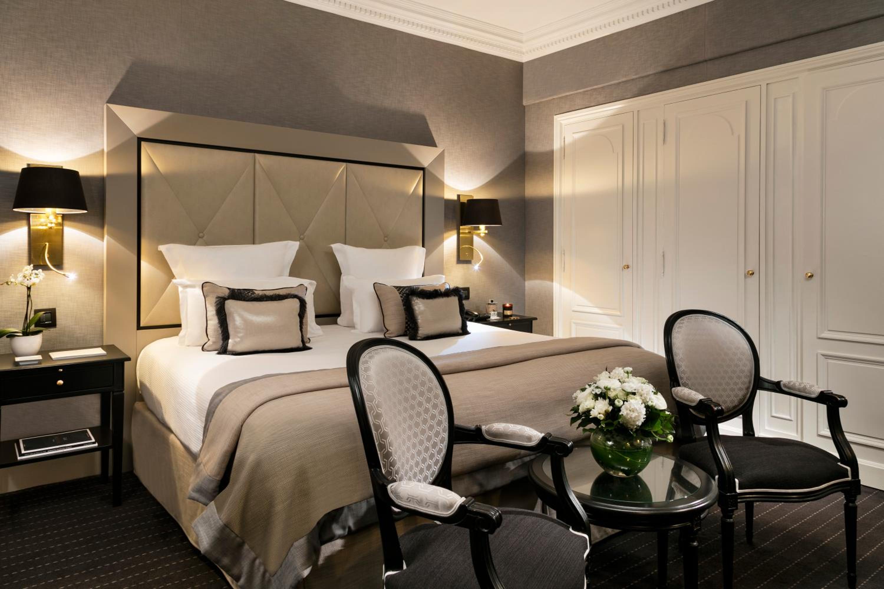 hotel room with a bed, chairs and a table