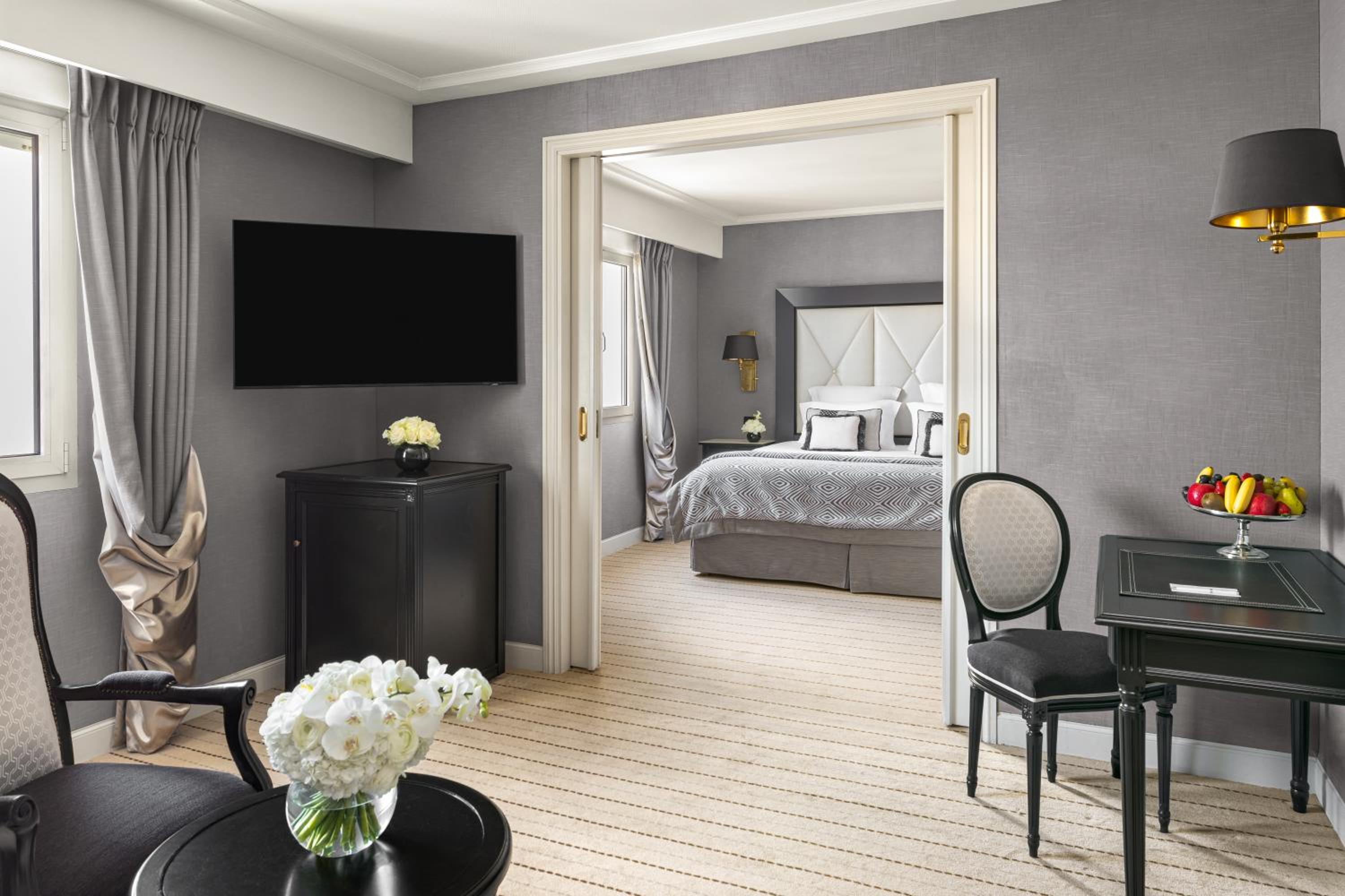 room with a bed, desk, chair and television