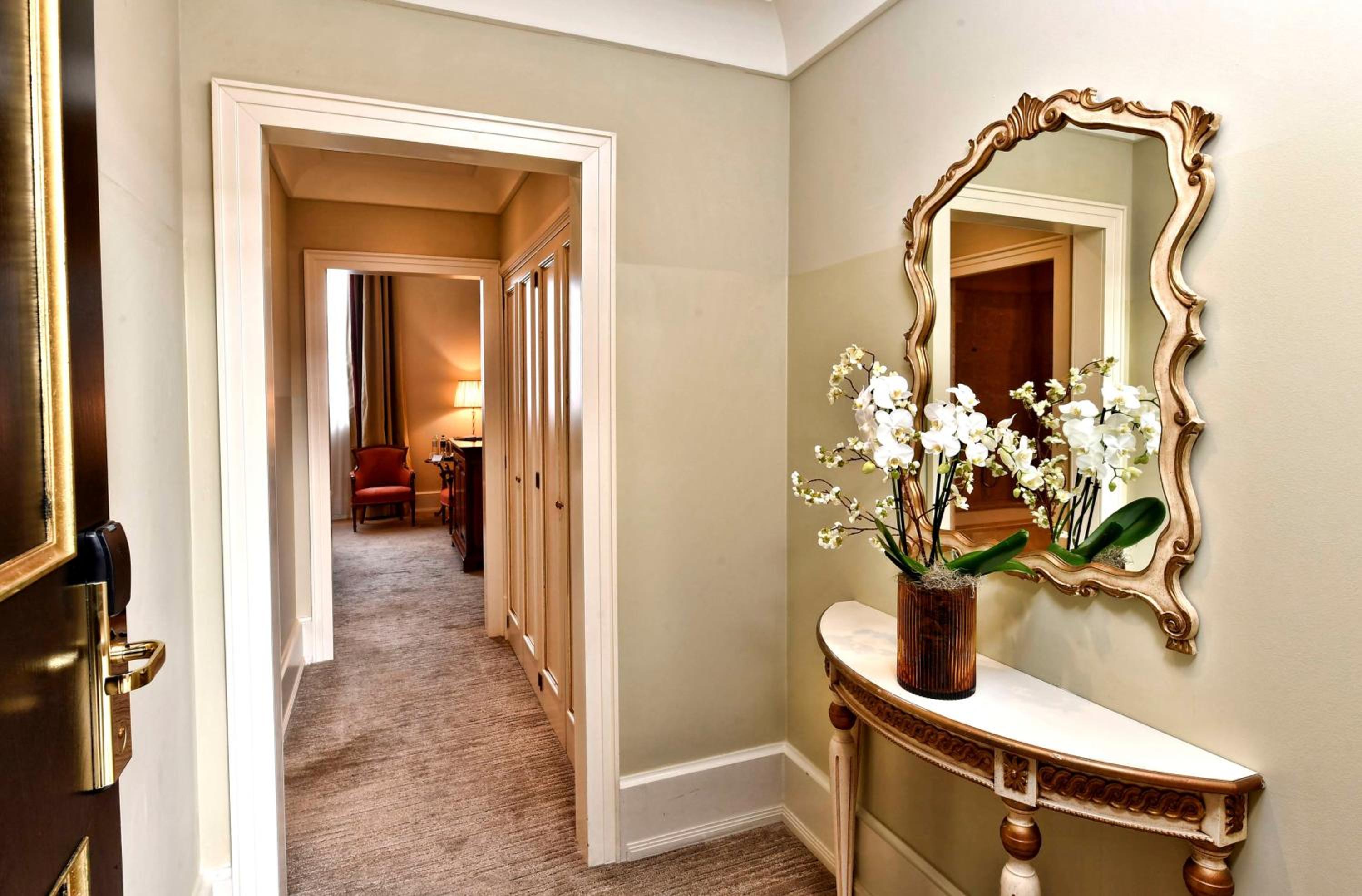 hallway with a vase of flowers on the side table