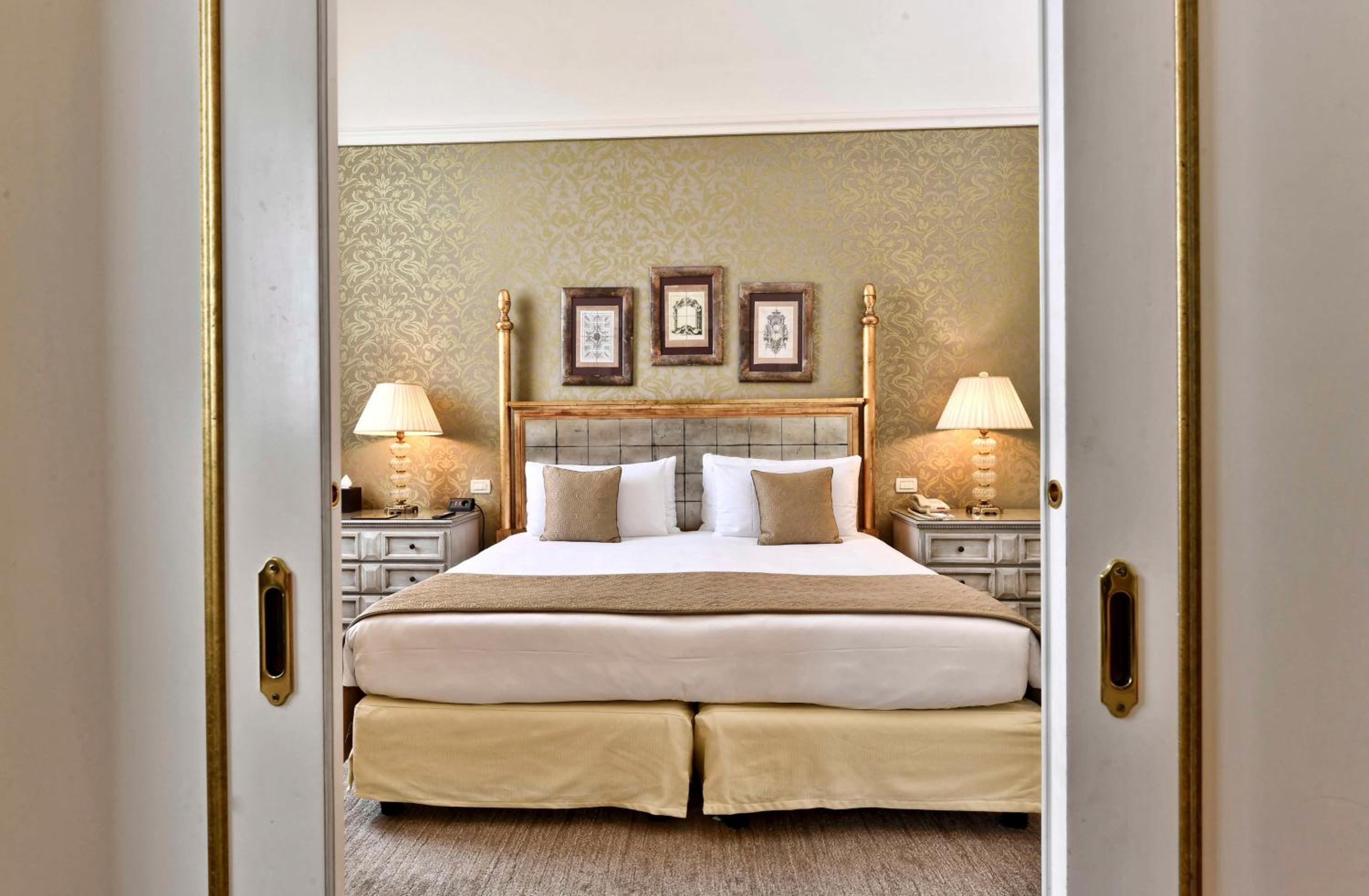 bedroom with a bed and two lamps on either side of the door