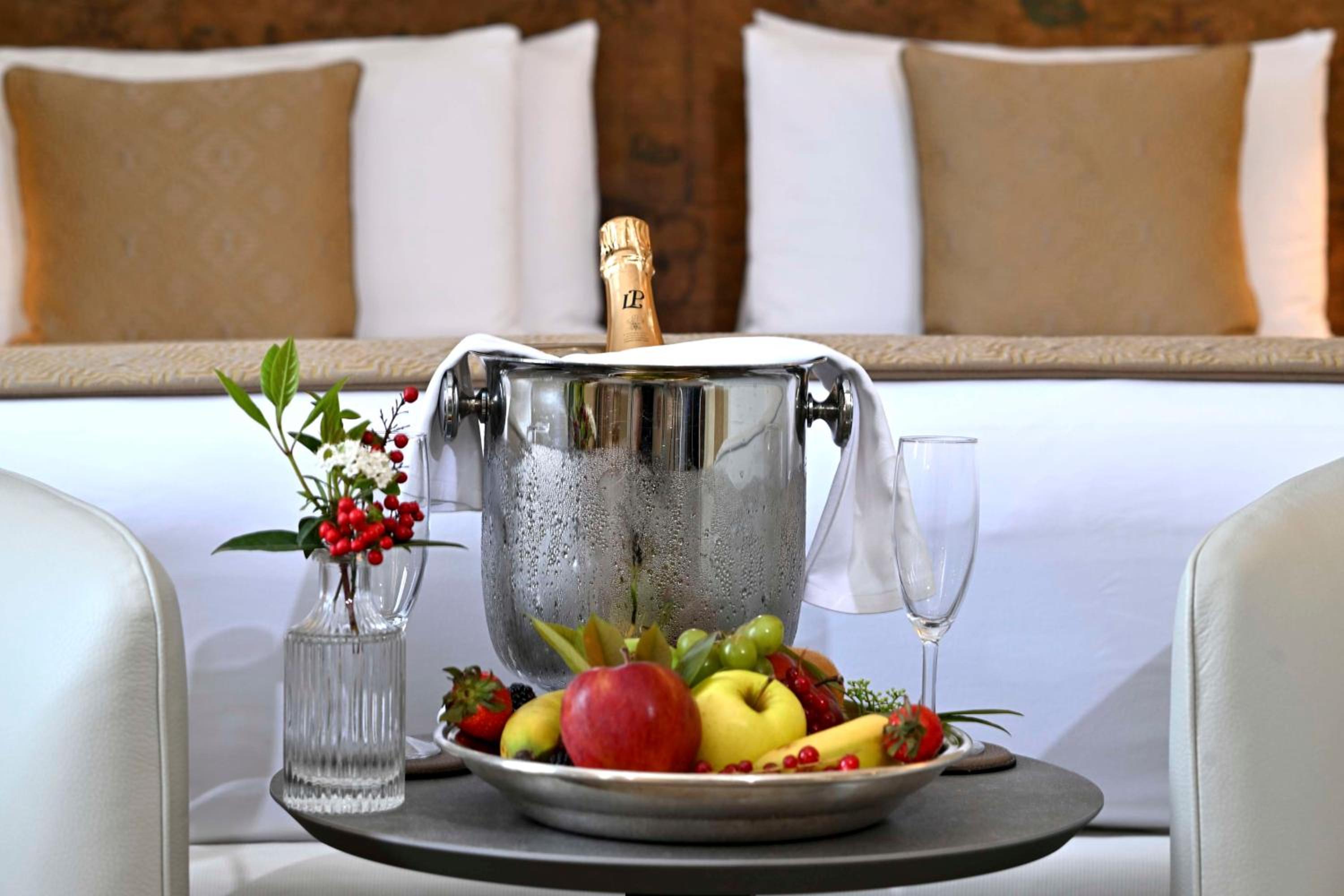 bottle of champagne and a plate of fruit on a tray