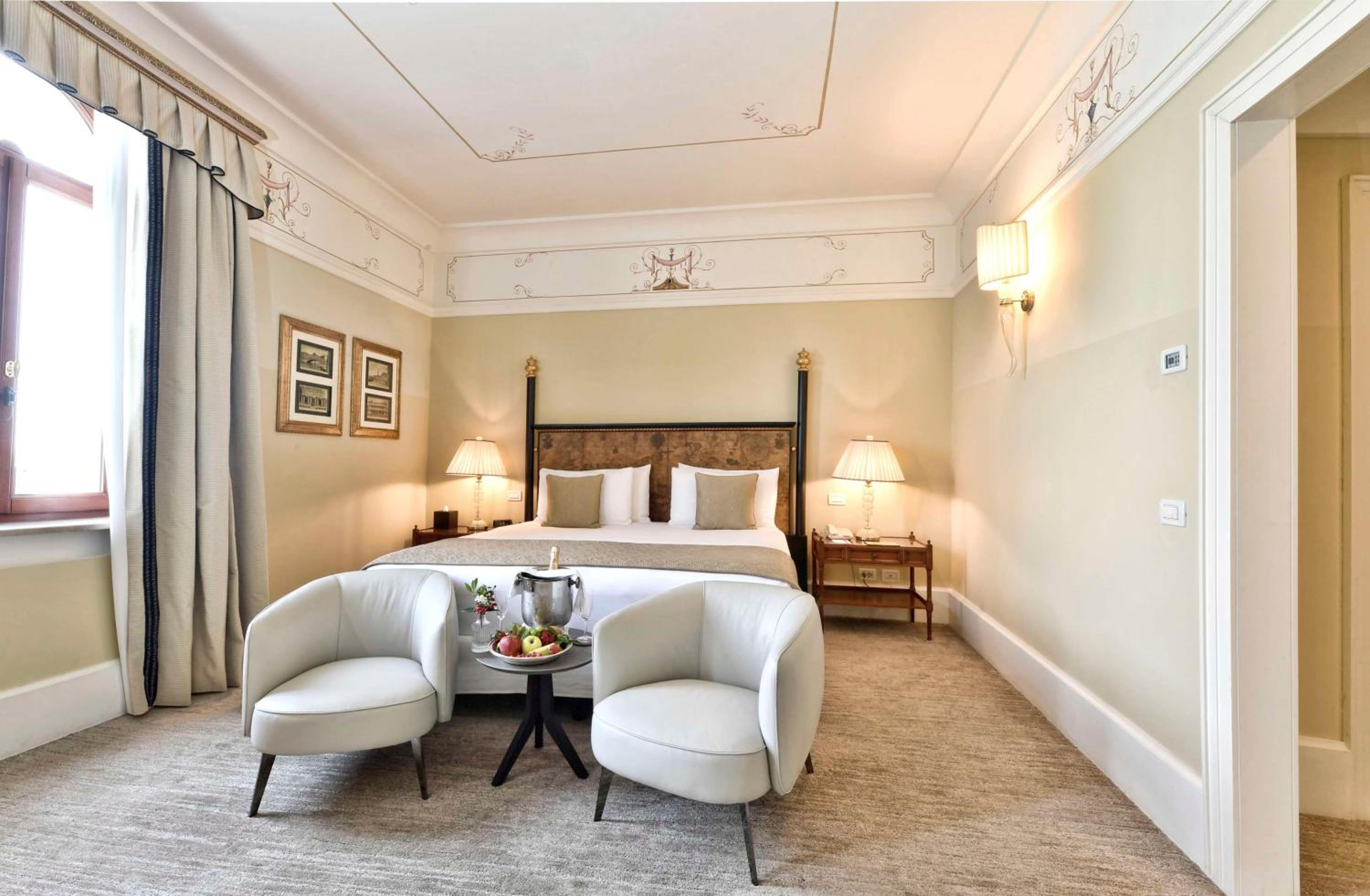 hotel room with a king size bed and two chairs
