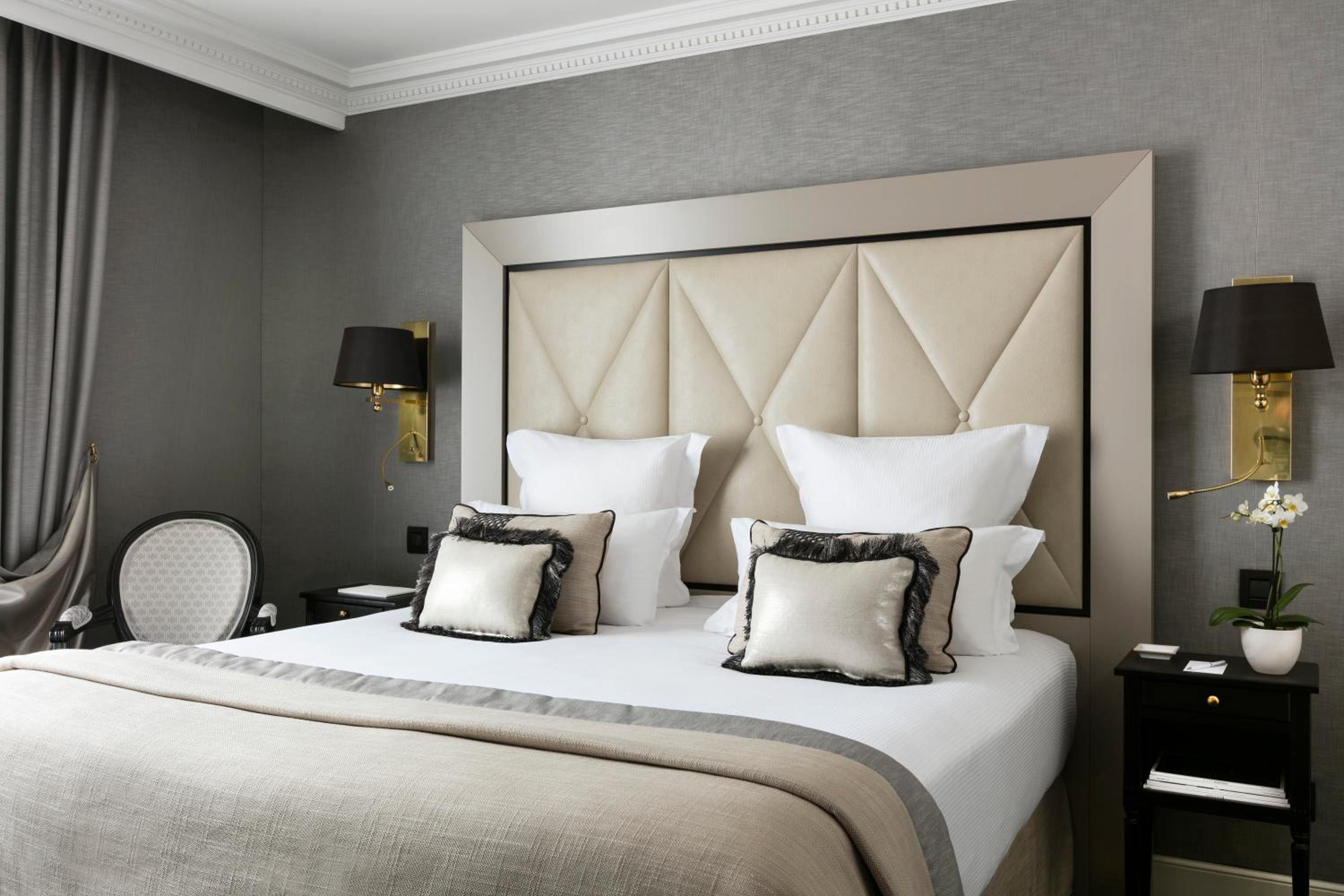 hotel room with a king size bed and two chairs