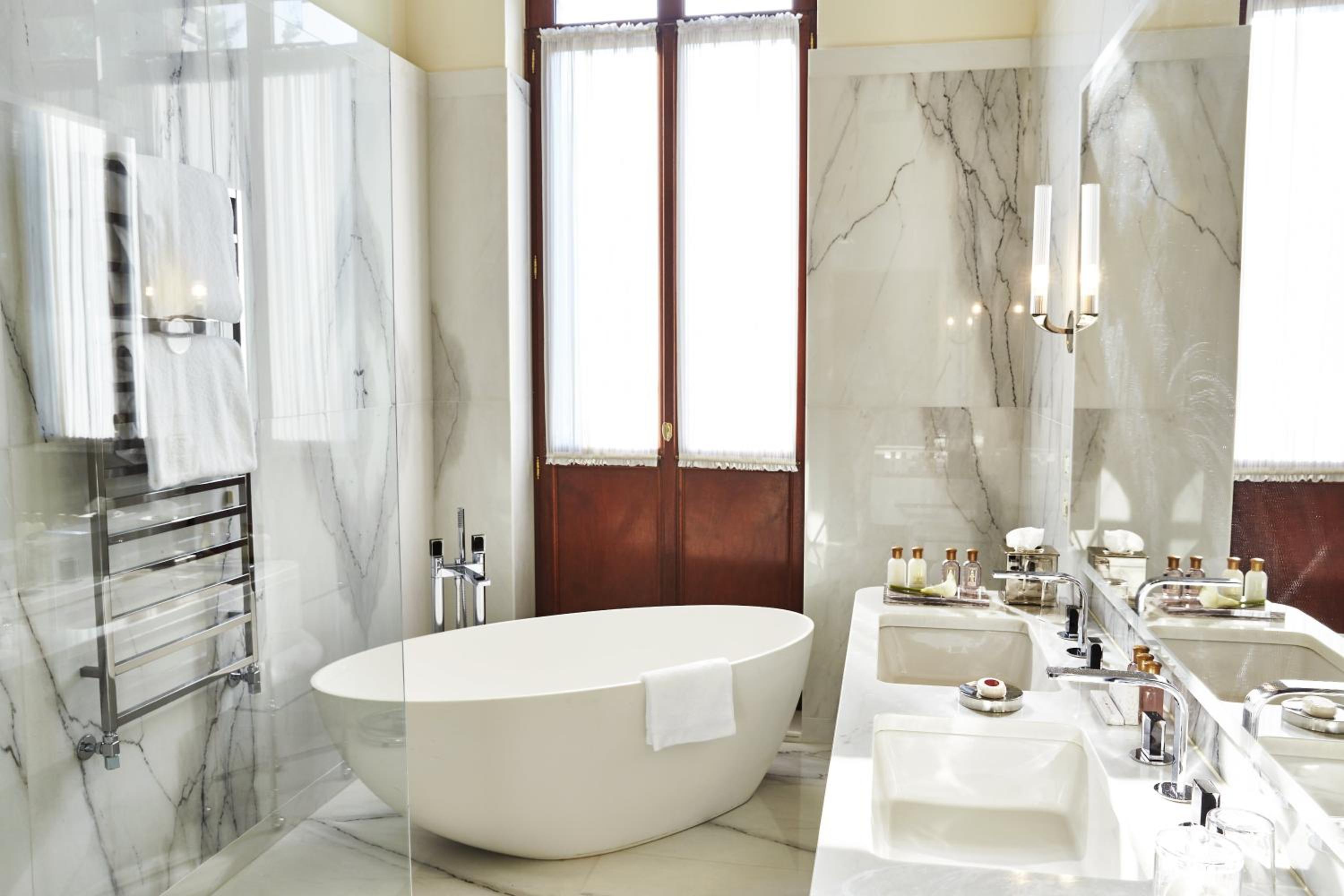 bathtub in the middle of a marbled bathroom