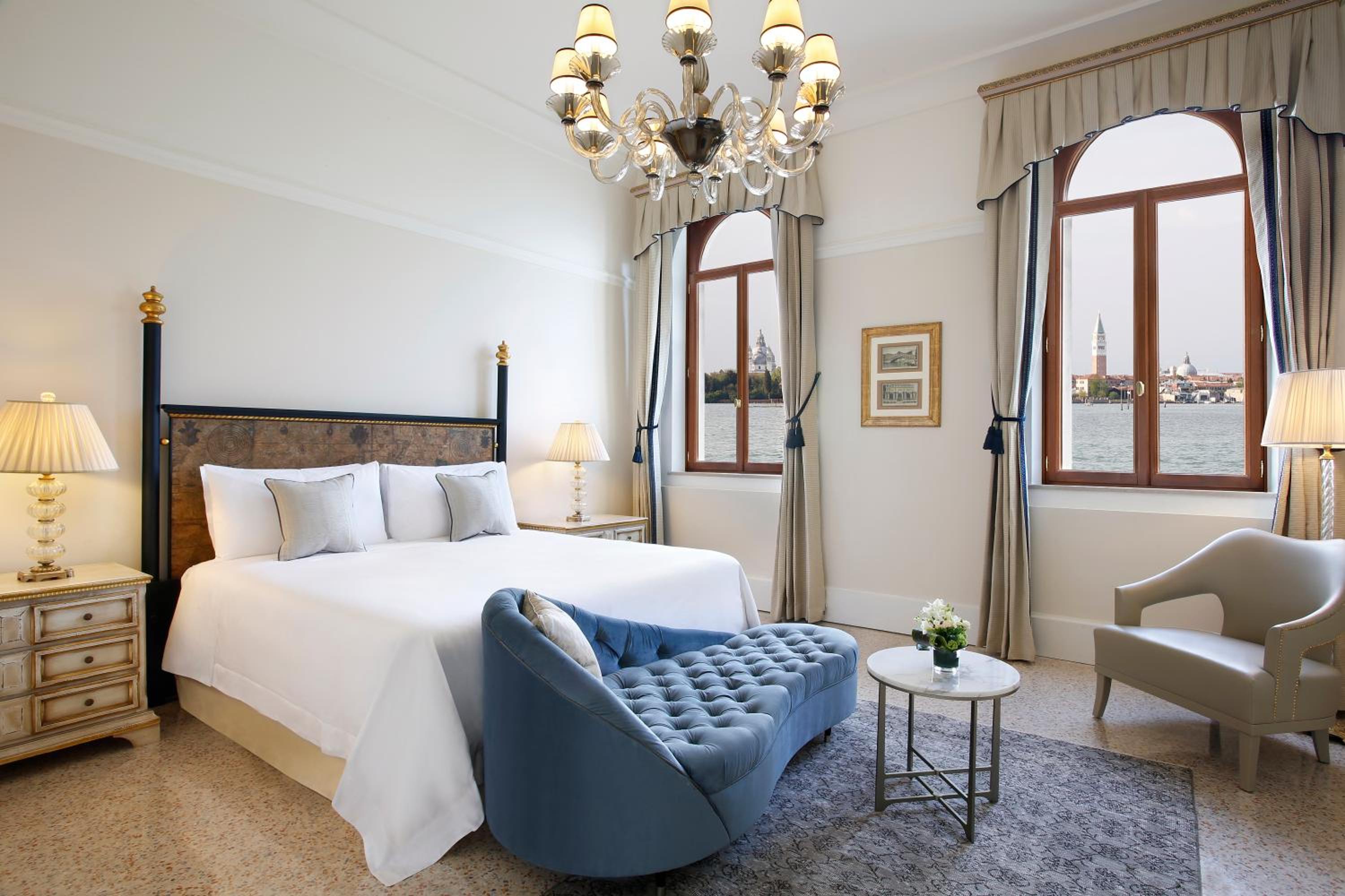 bedroom with a bed, chair, and chandelier