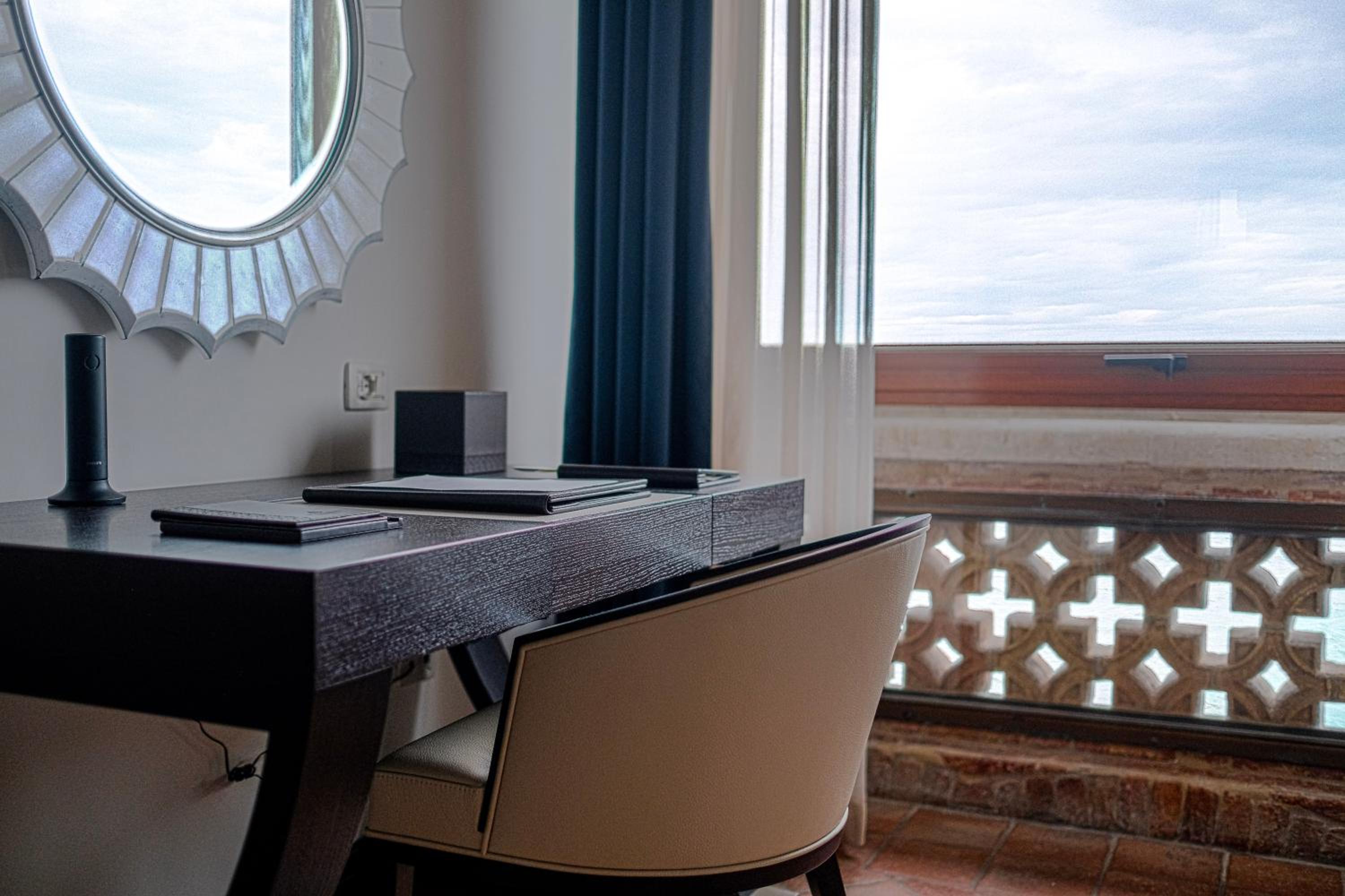desk with a chair and a mirror on the wall