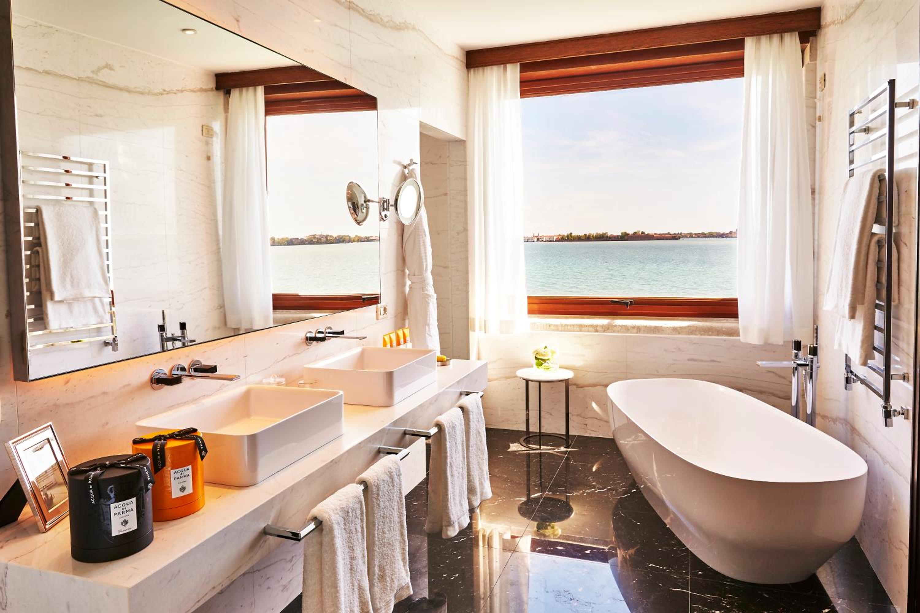 bathroom with a bathtub and a large window overlooking the water