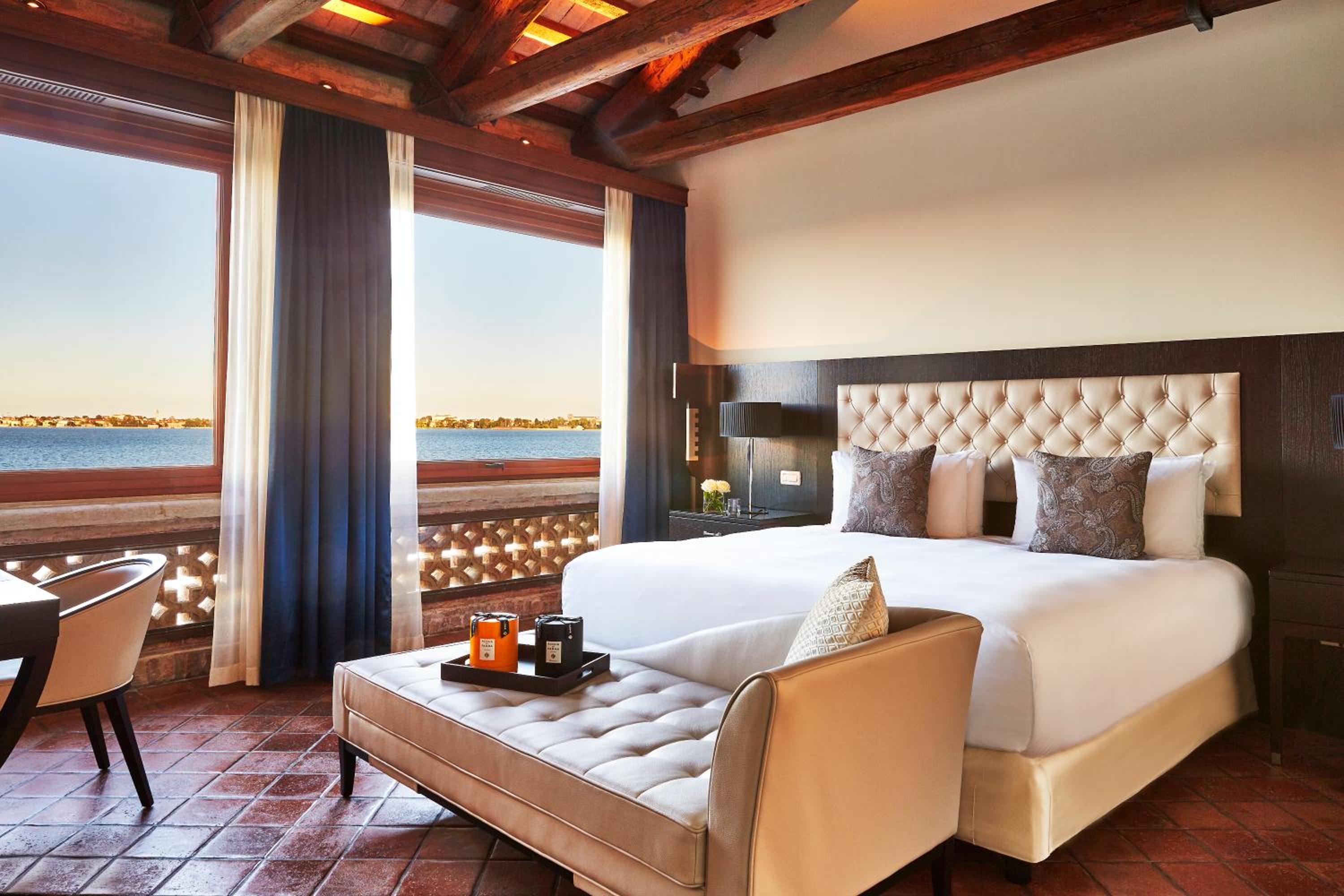 hotel room with a large bed and a view of the ocean