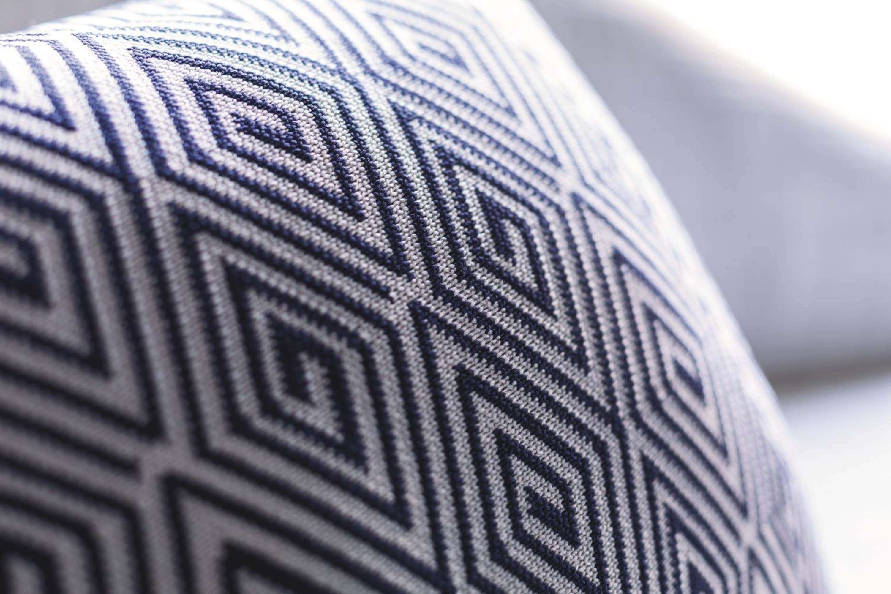 close up shot of a blue and white patterned pillow