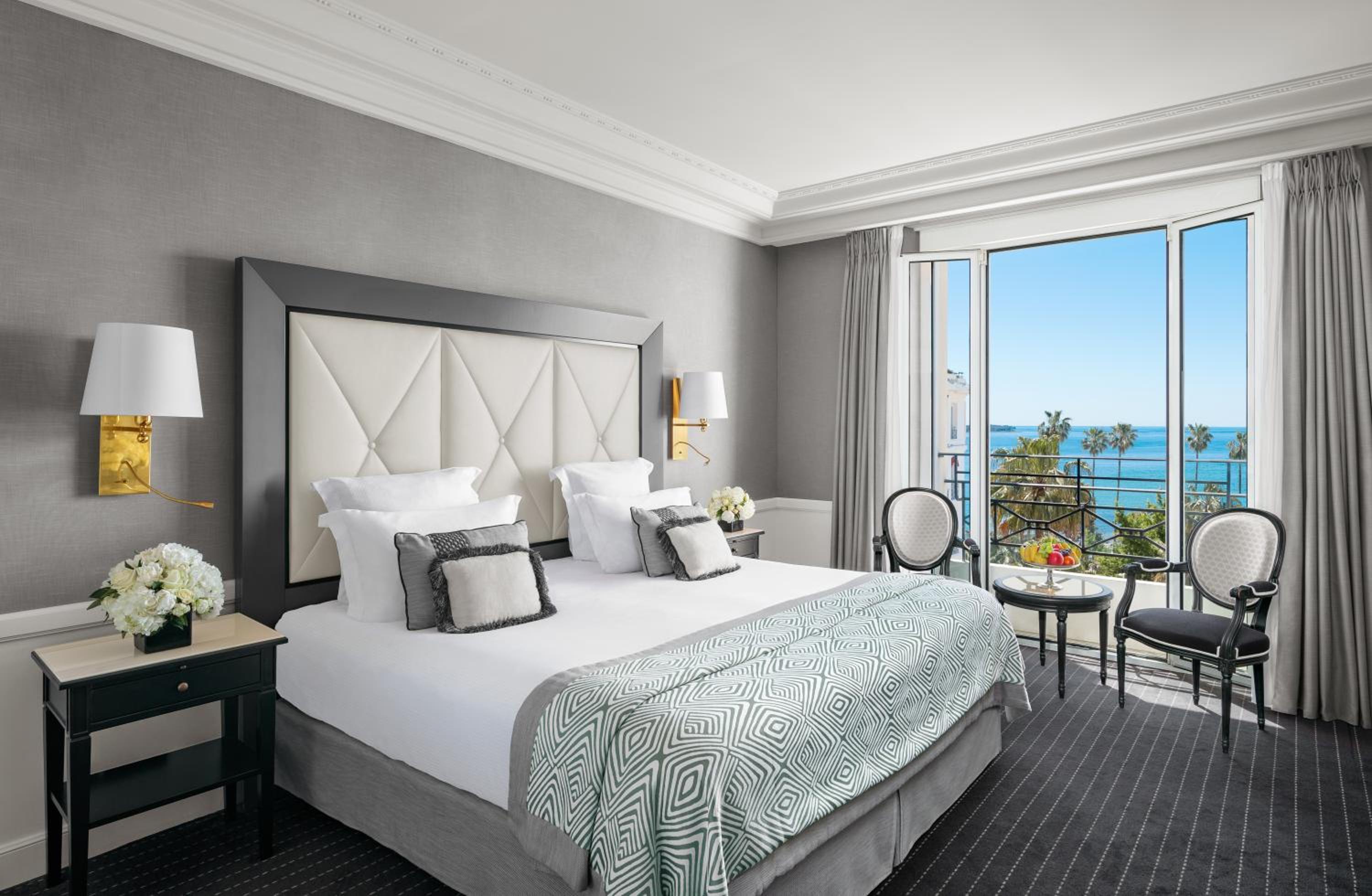 hotel room with a large bed and a view of the ocean