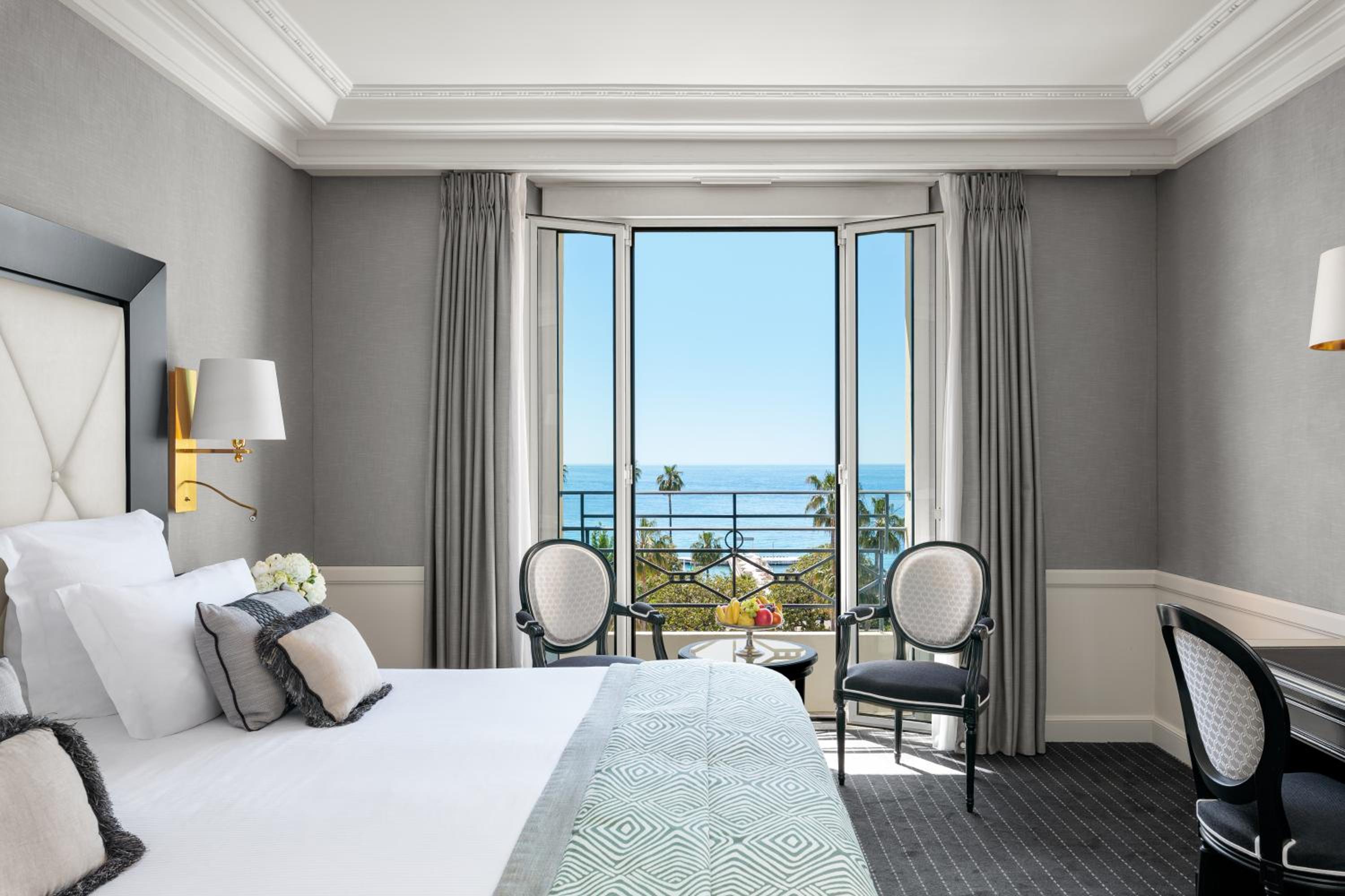 hotel room with a view of the ocean and mountains