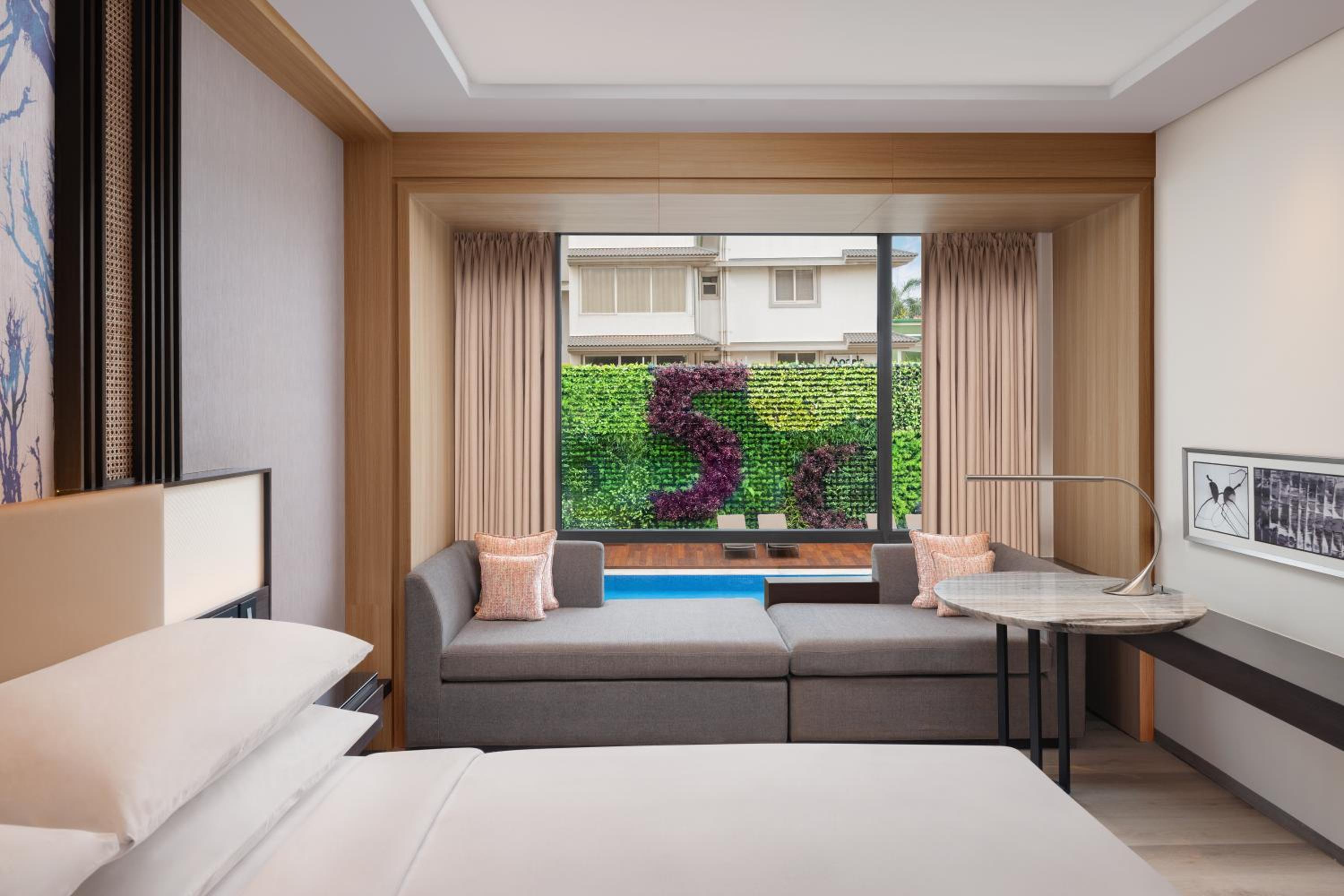 Deluxe Guest room, 1 King, Partial pool view with INR 500 Spa credit on min therapy of 60 mins per stay - Photo 1