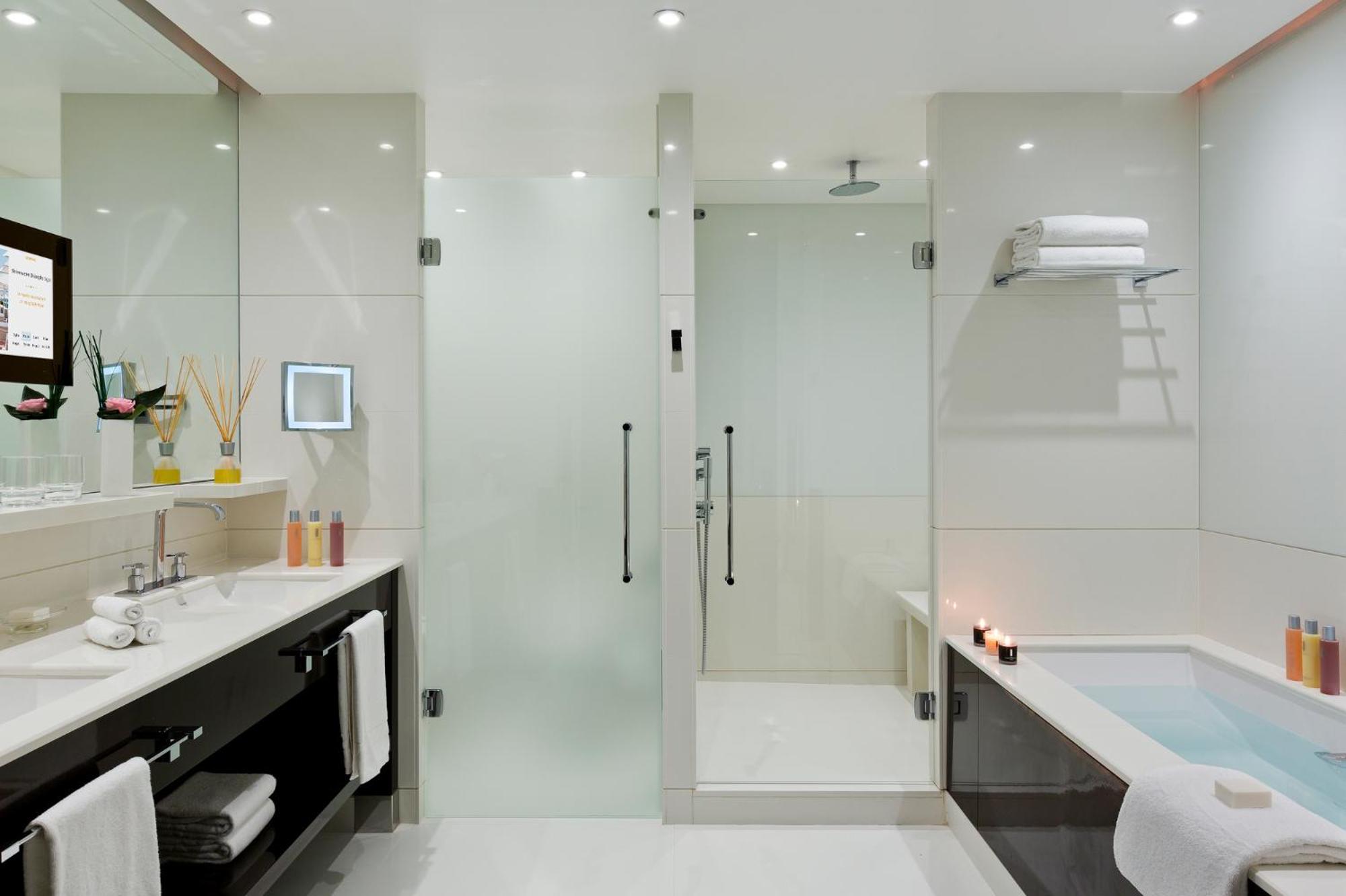 bathroom with a walk in shower and a bathtub