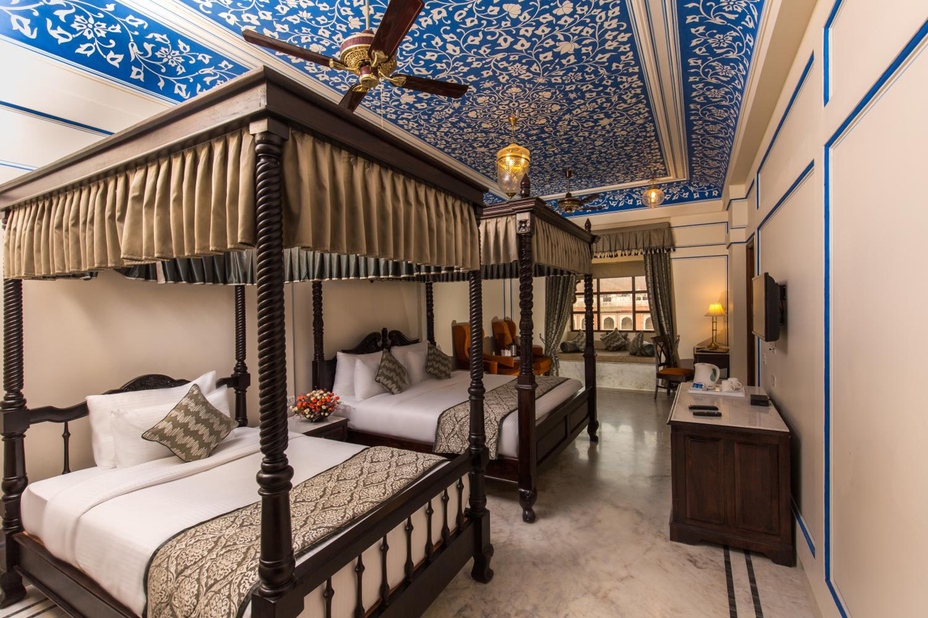 Royal Suite -Enjoy 20% off on spa services. Experience a daily Rajasthani dance & music show from 7–9 PM, complimentary use of two swimming pools, free access to the game room & gym, kids stay complimentary, and a travel desk for local tours & activities.