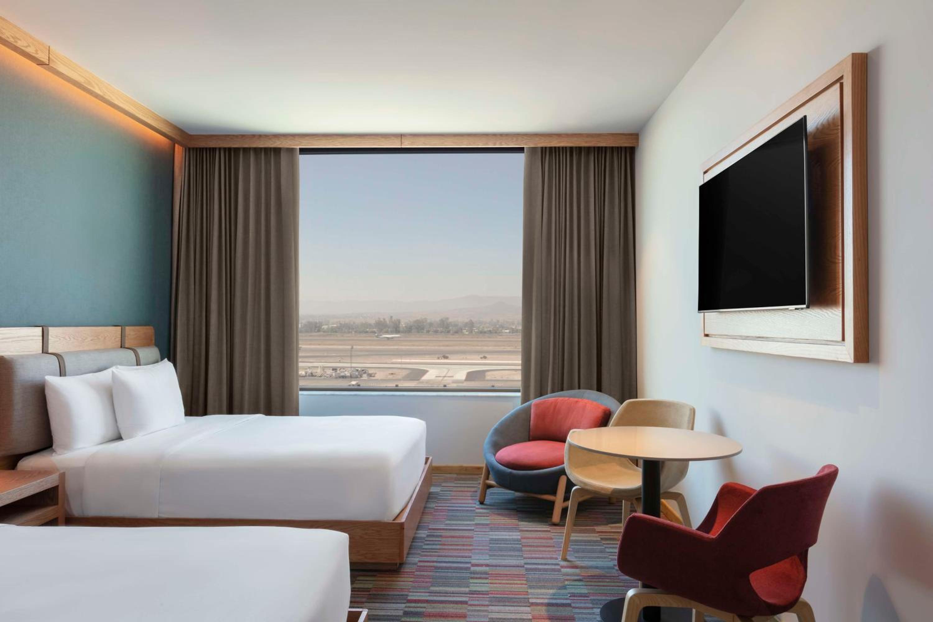 Queen Room with Two Queen Beds and Airport View - Photo 1