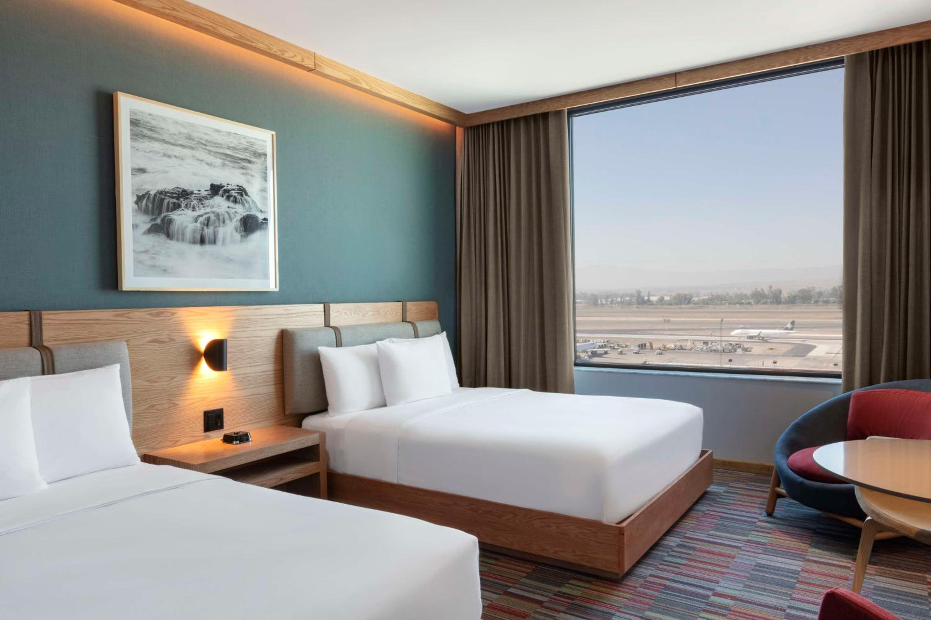 Queen Room with Two Queen Beds and Airport View - Photo 2