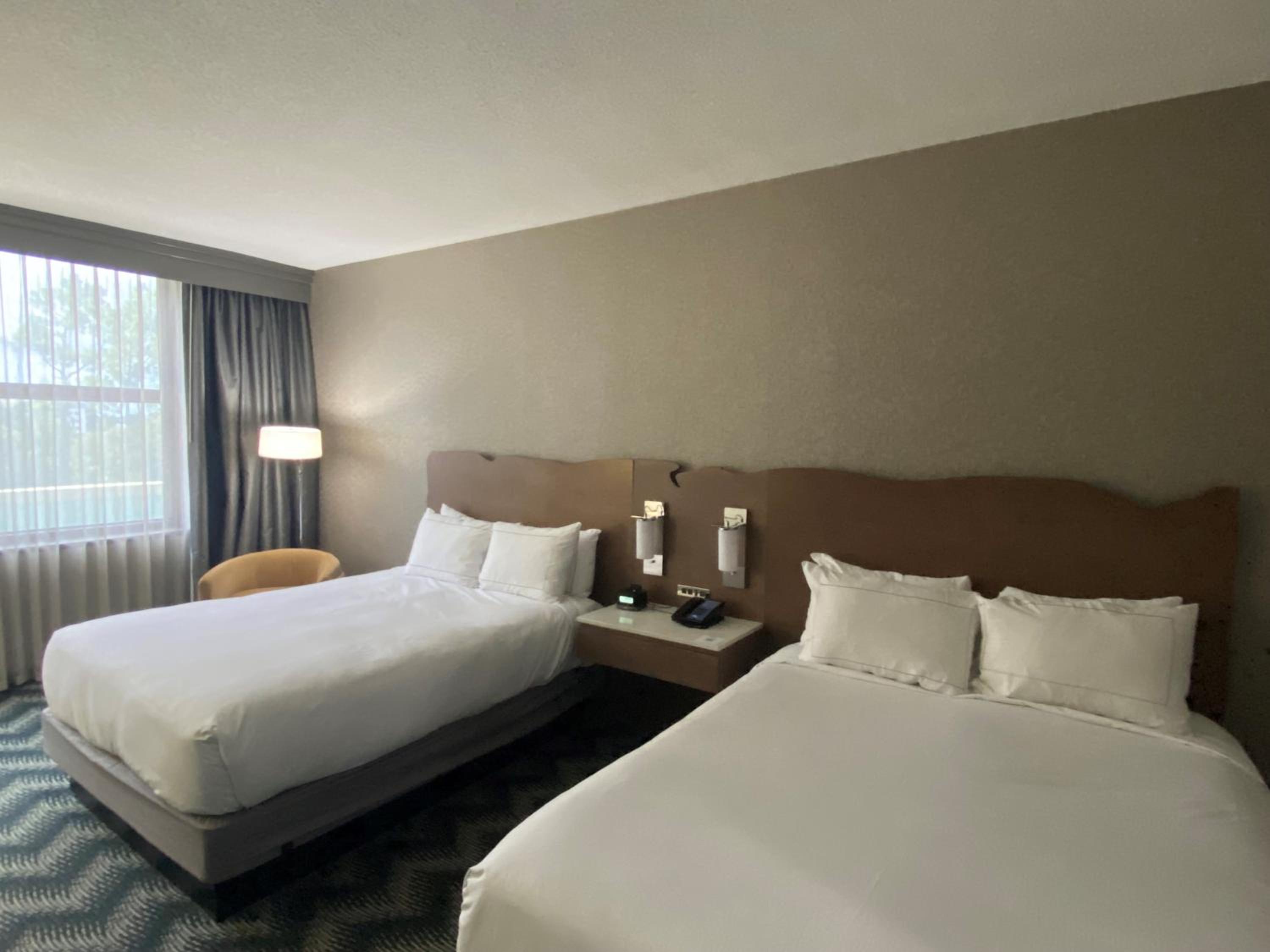Queen Room with Two Queen Beds and Bath Tub - Mobility Accessible at Hilton Houston North in Houston