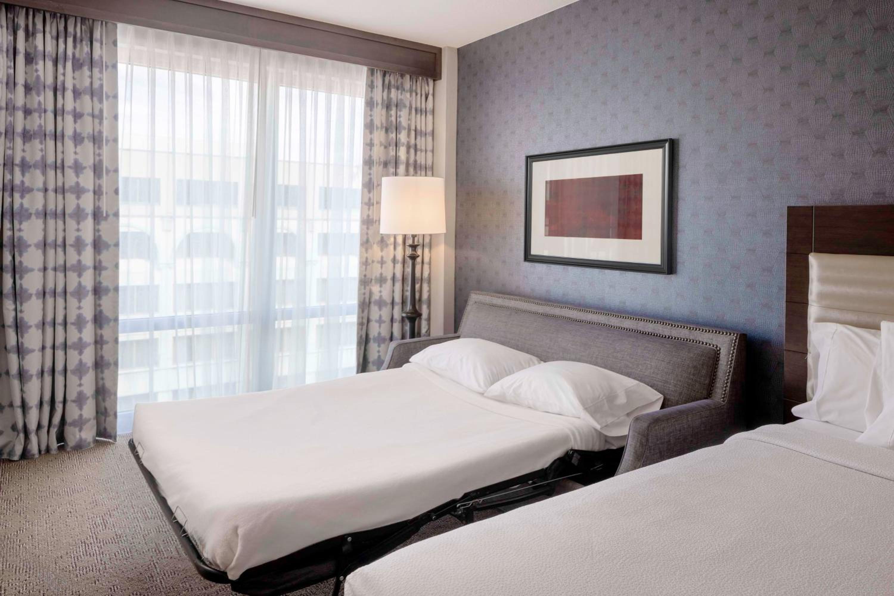 Deluxe Queen Room with Two Queen Beds and Sofa Bed photo 1