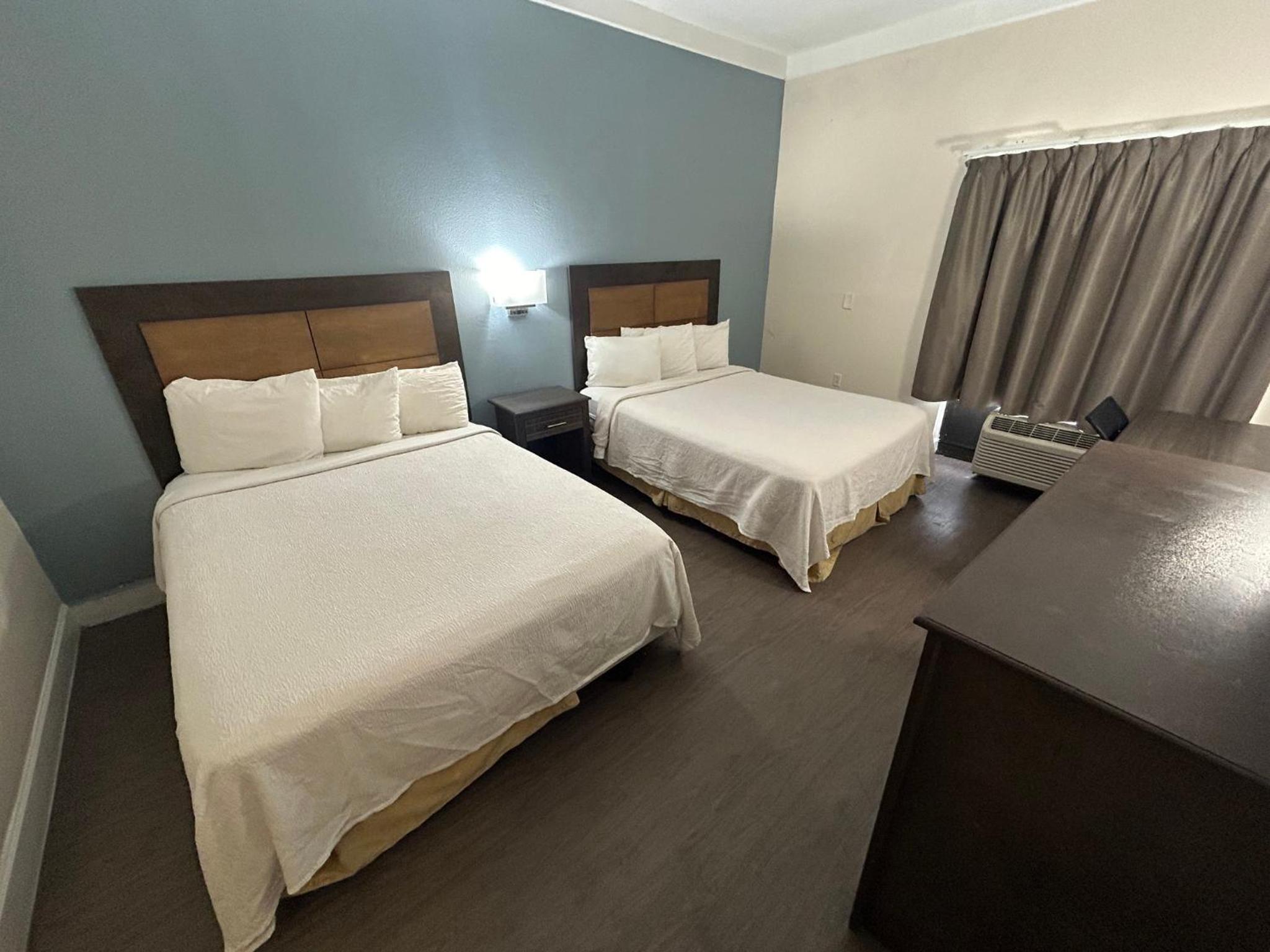 Premium Room with Two Queen Beds Disability Access Roll-In Shower Smoke Free (Upgraded Bedding and Snack Box) - Photo 1