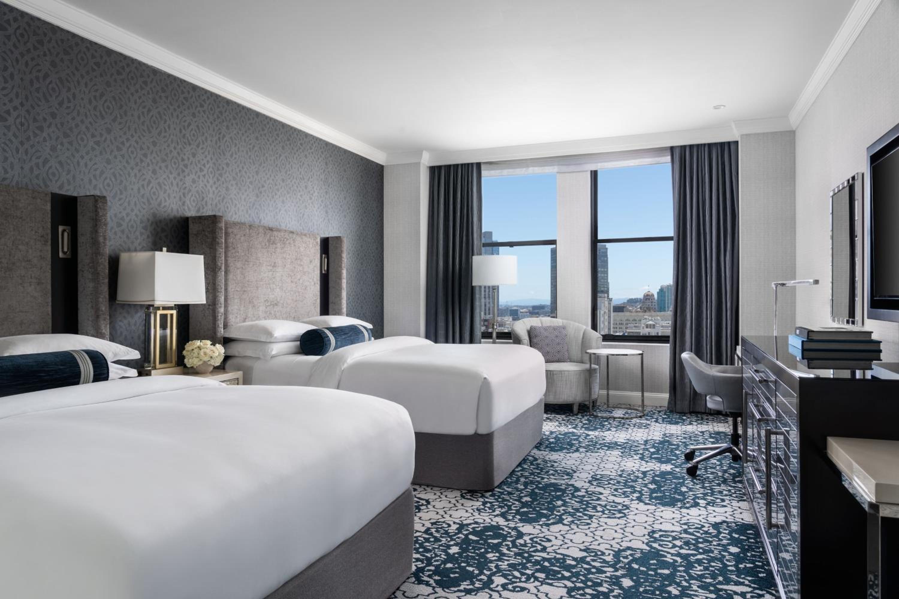 hotel room with two beds and a flat screen tv