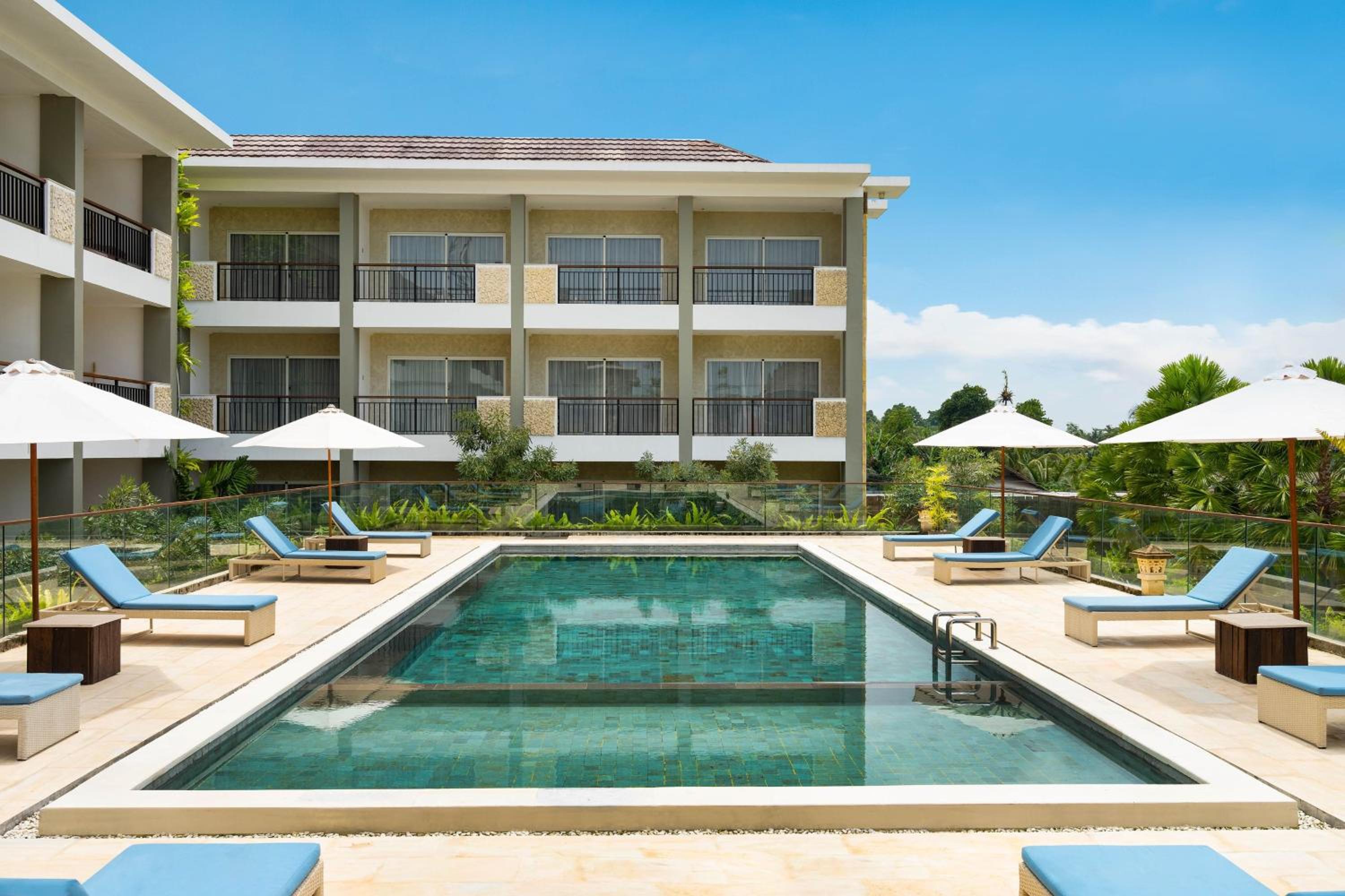 Deluxe King Balcony Room with Pool View, with FREE daily shuttle to Ubud City, FREE Photo Session, FREE Art Gallery Visit, 24-hour access to Fitness Center, FREE Welcome Drink, and FREE Kids Activities. photo 3