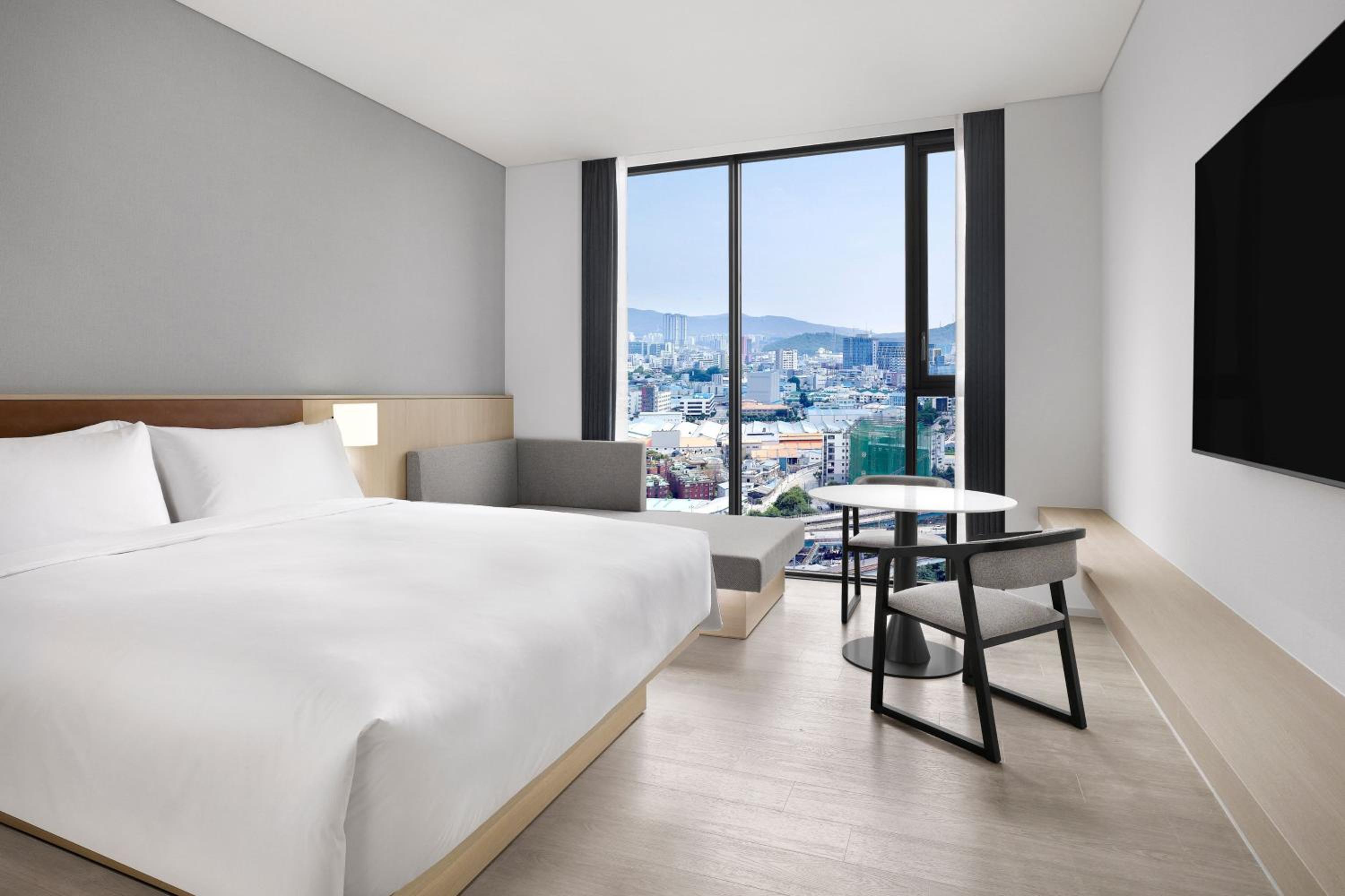 Deluxe King Room with Sofa Bed and City View - Photo 1