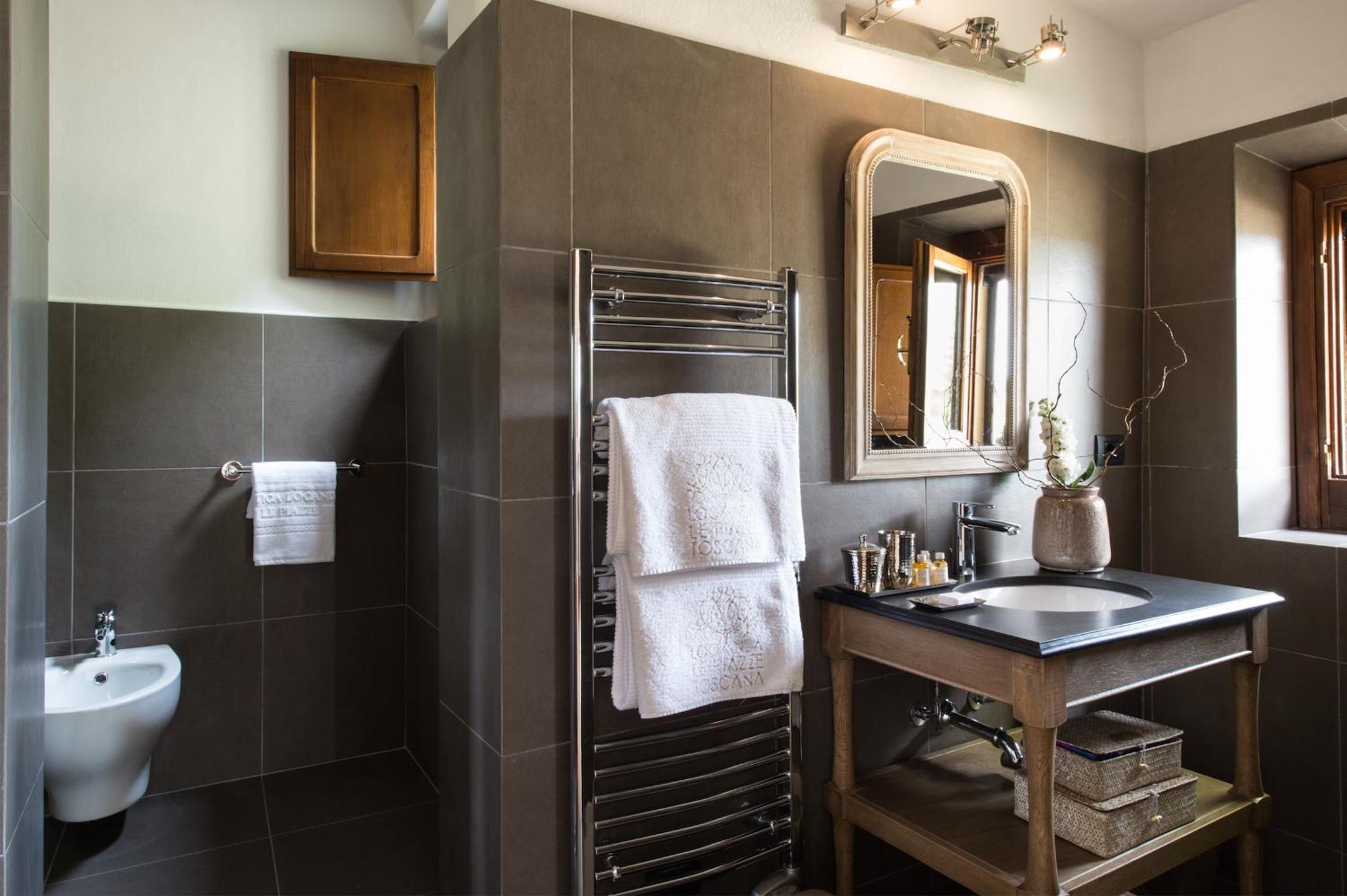bathroom with a sink, mirror, and towel rack