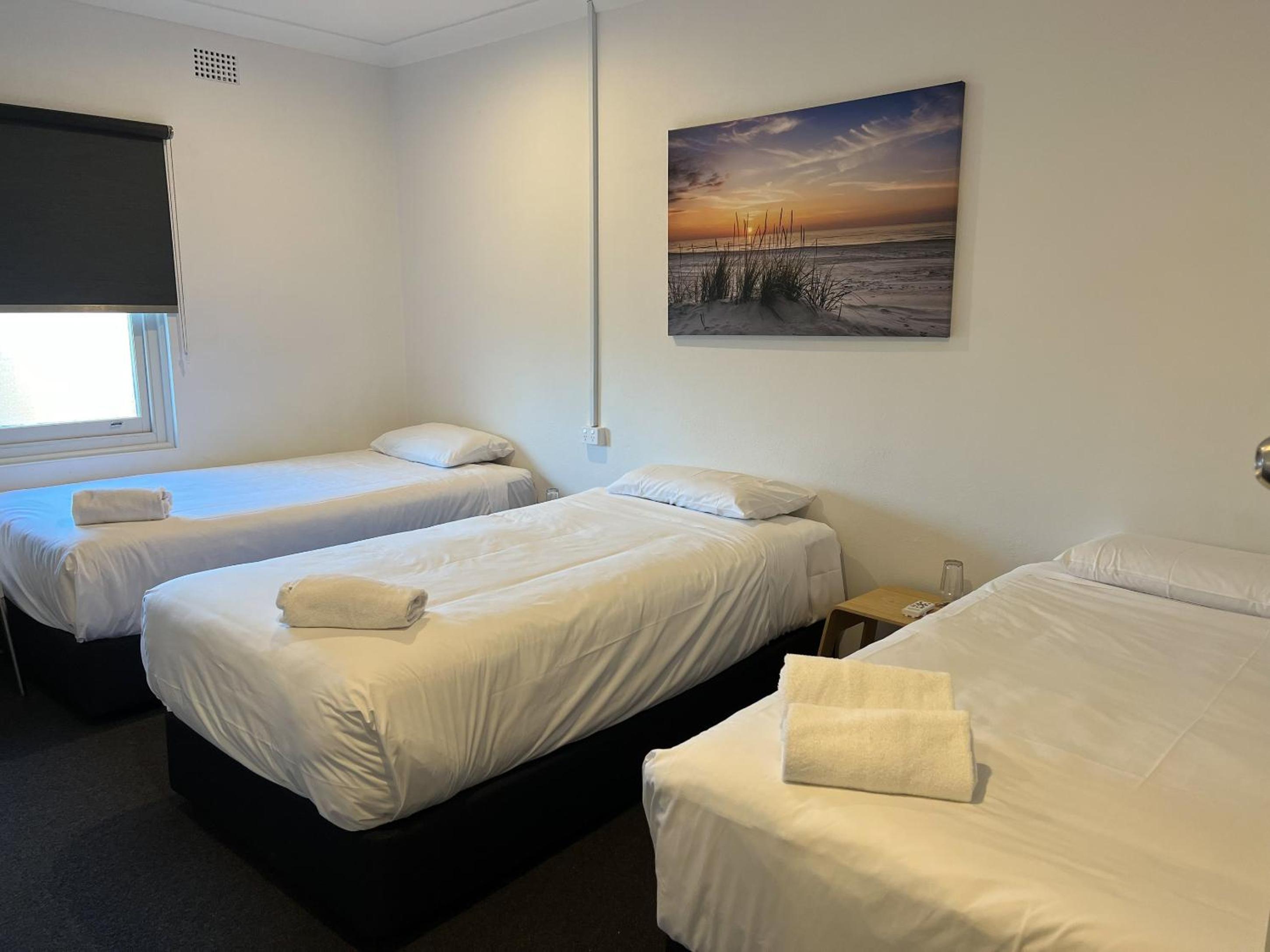 Quadruple Room with Two Single Beds, One Double Bed and Shared Bathroom