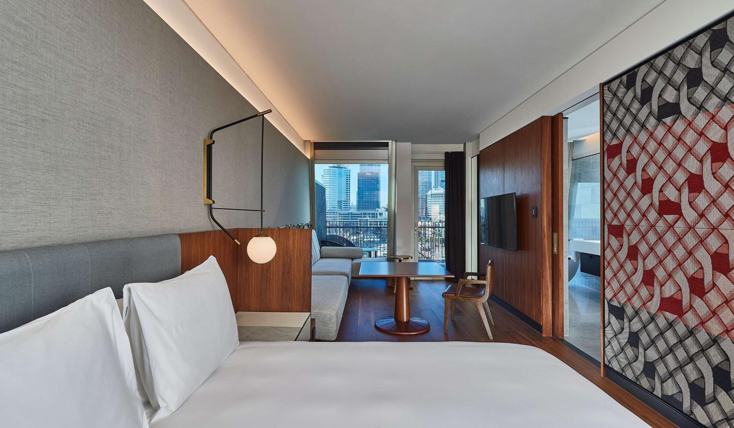 hotel room with a bed and a view of the city