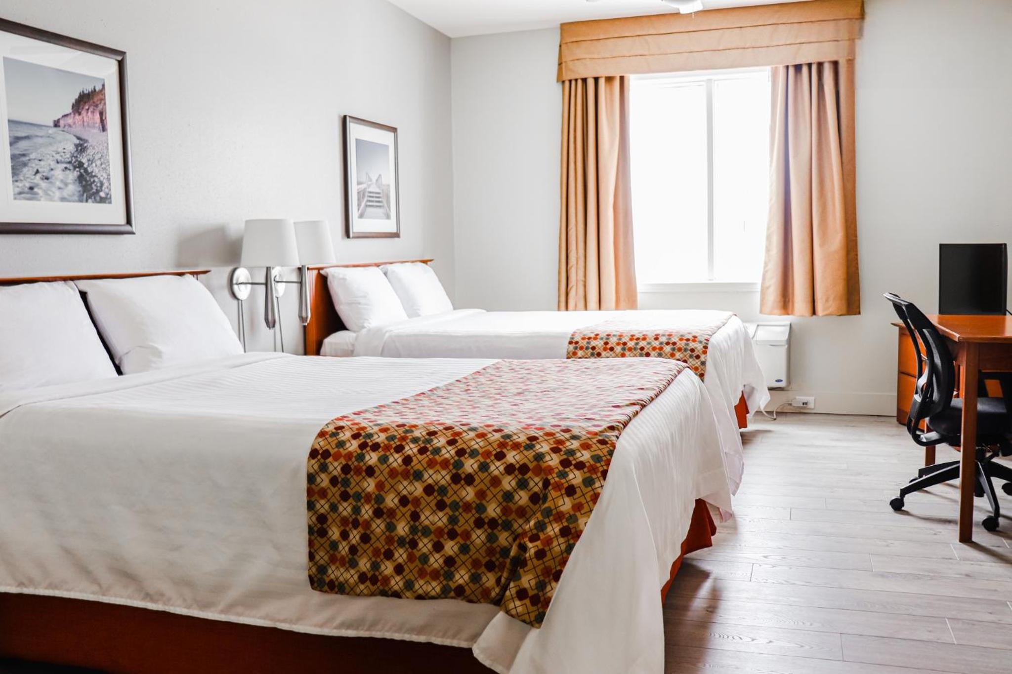 Queen Room with Two Queen Beds and One Single Bed - Non-Smoking - Photo 1